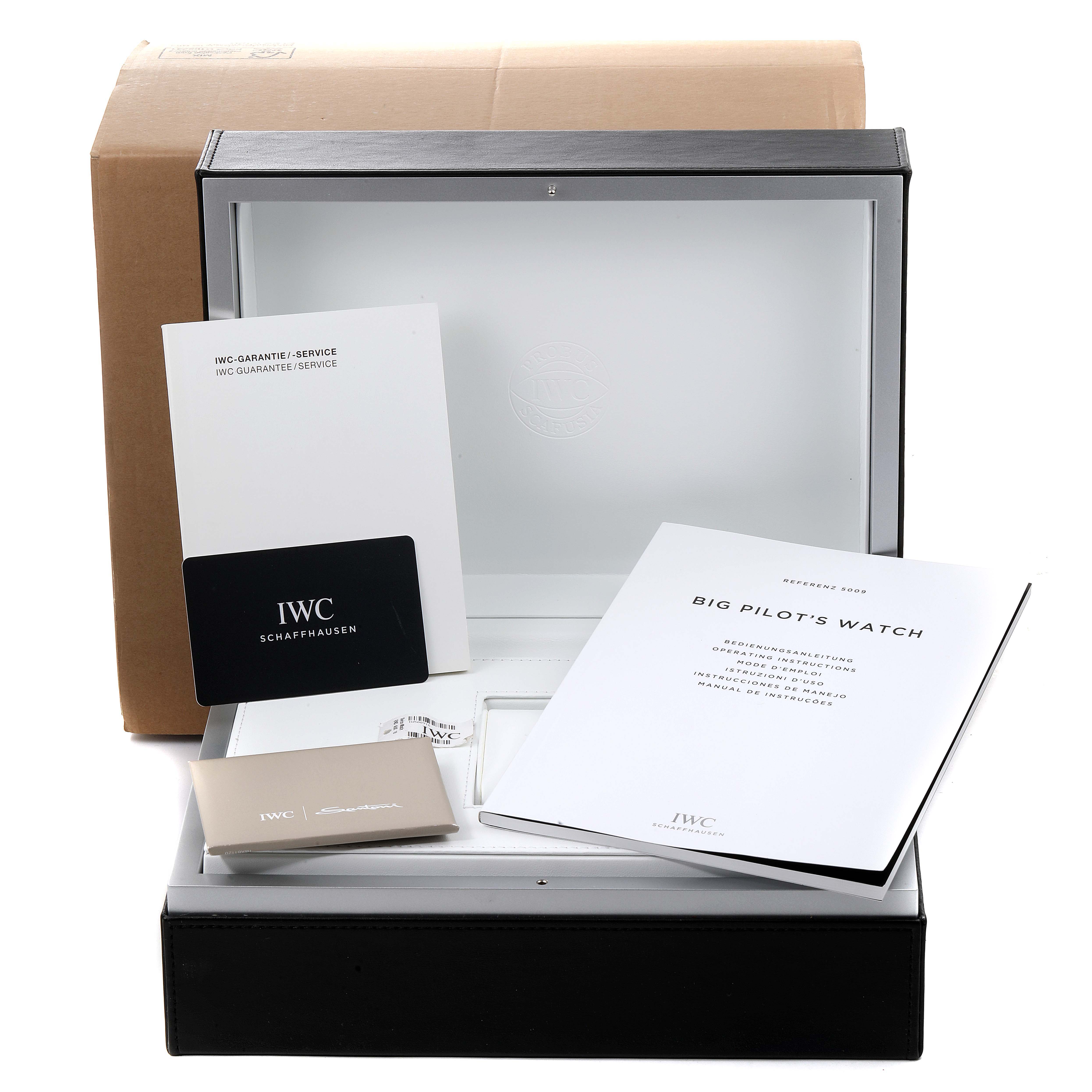 The image shows the packaging and documentation for an IWC Big Pilot's Watch, including the box, manuals, and warranty card.