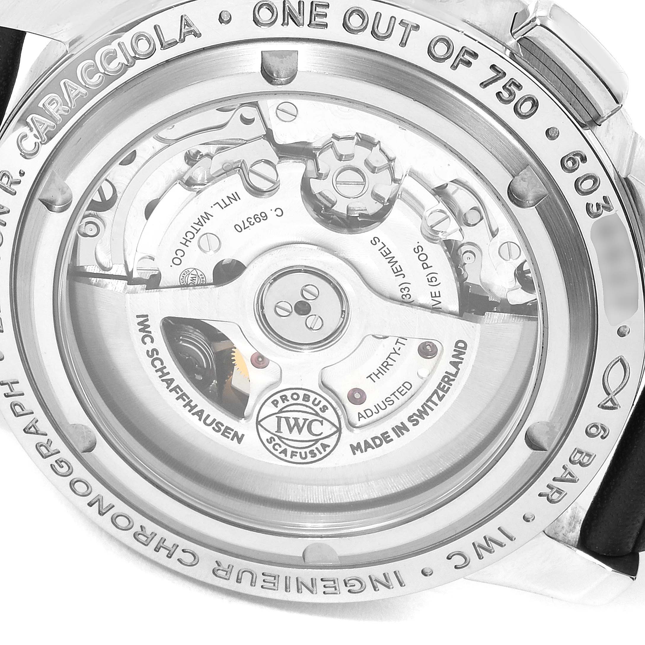 The image shows the case back of an IWC Ingenieur IW380702 Men's Stainless Steel Grey Dial IW380702 Men's Stainless Steel Grey Dial watch, revealing the inner mechanical movement and some engravings.