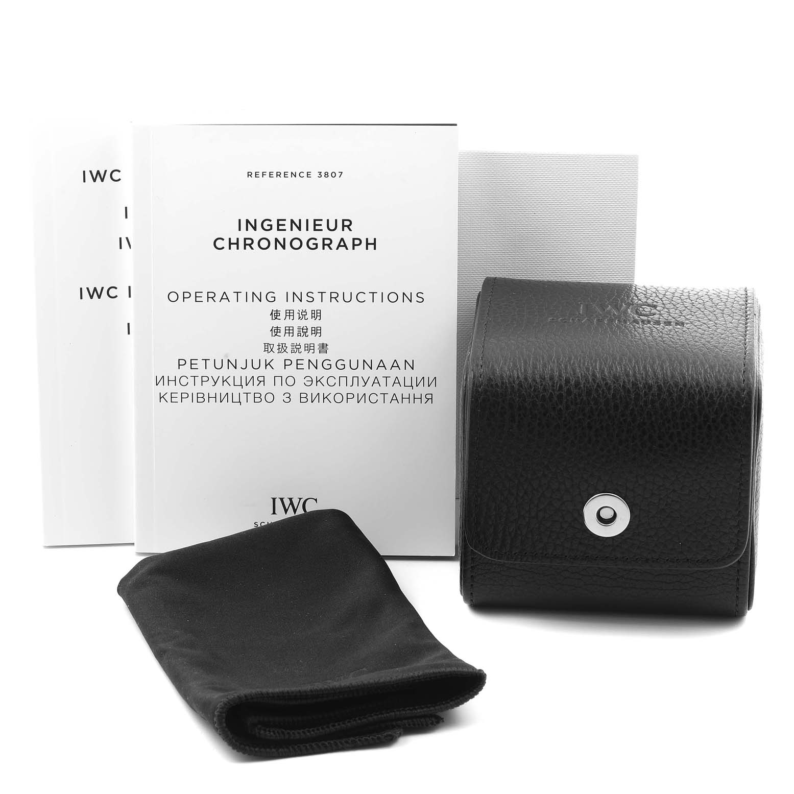The image shows IWC Ingenieur IW380702 Men's Stainless Steel Grey Dial IW380702 Men's Stainless Steel Grey Dial Chronograph operating instructions, a cleaning cloth, and a black leather carrying case.