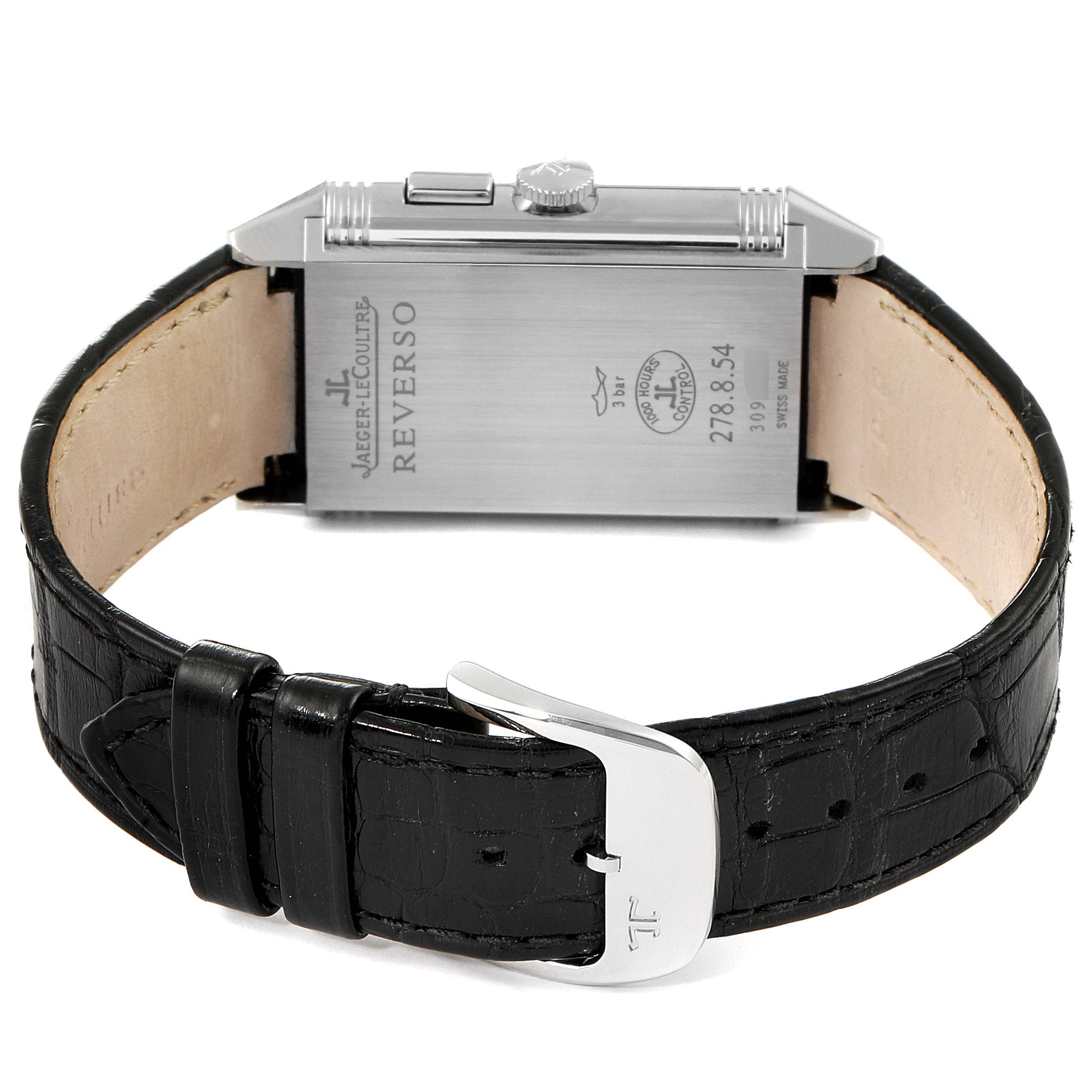 This image shows the back view of the Jaeger-LeCoultre Reverso watch with its black leather strap and metallic buckle.