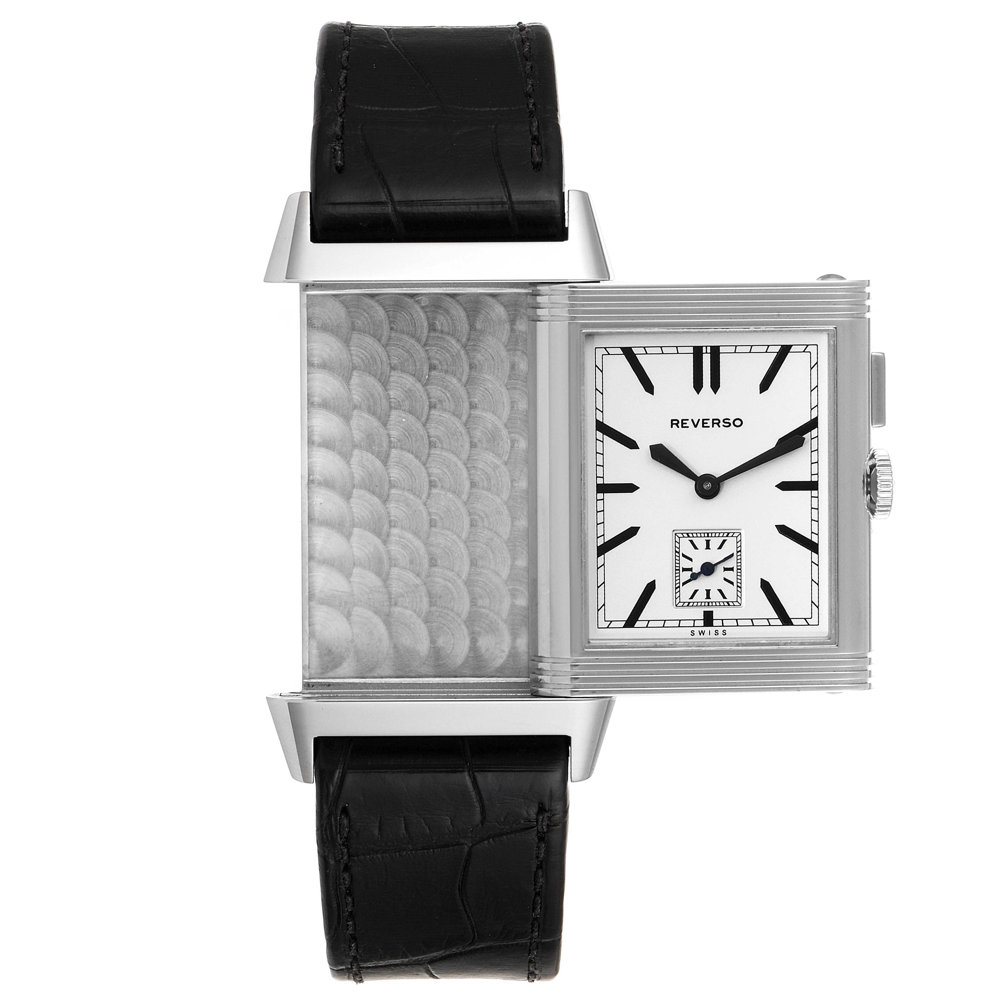 The image shows a Jaeger-LeCoultre Reverso watch in a partially flipped position, revealing both the interior case back and the dial.