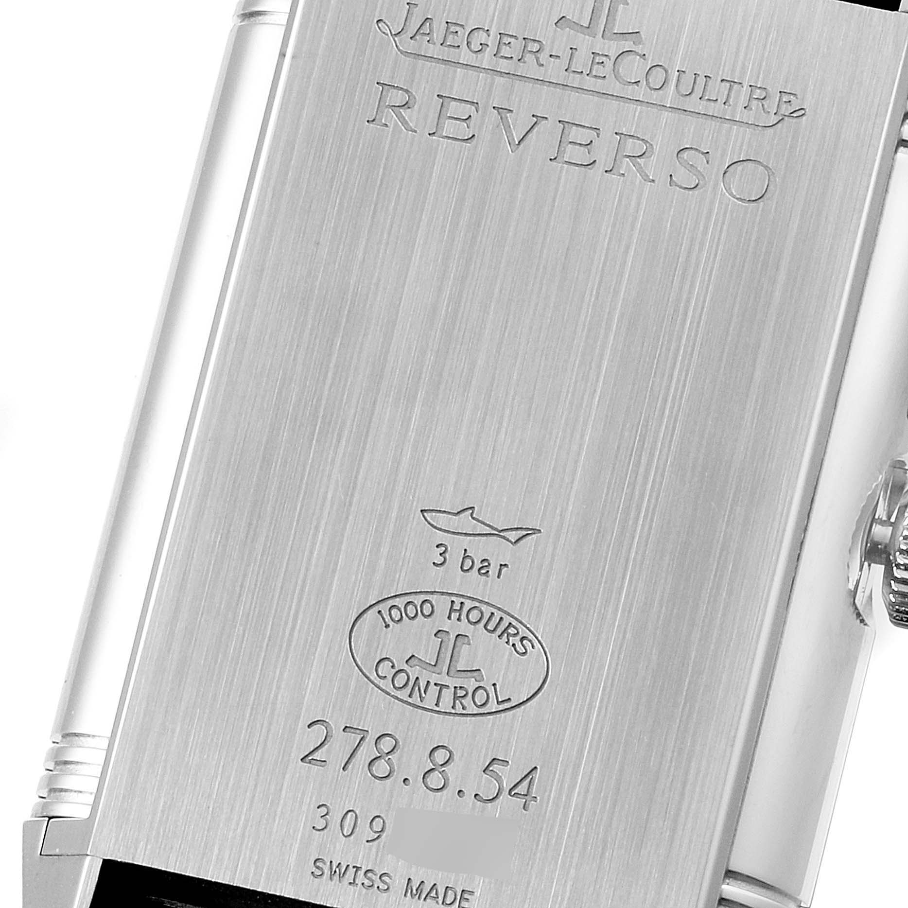 This image shows the back of a Jaeger-LeCoultre Reverso watch, highlighting engravings and the crown side.