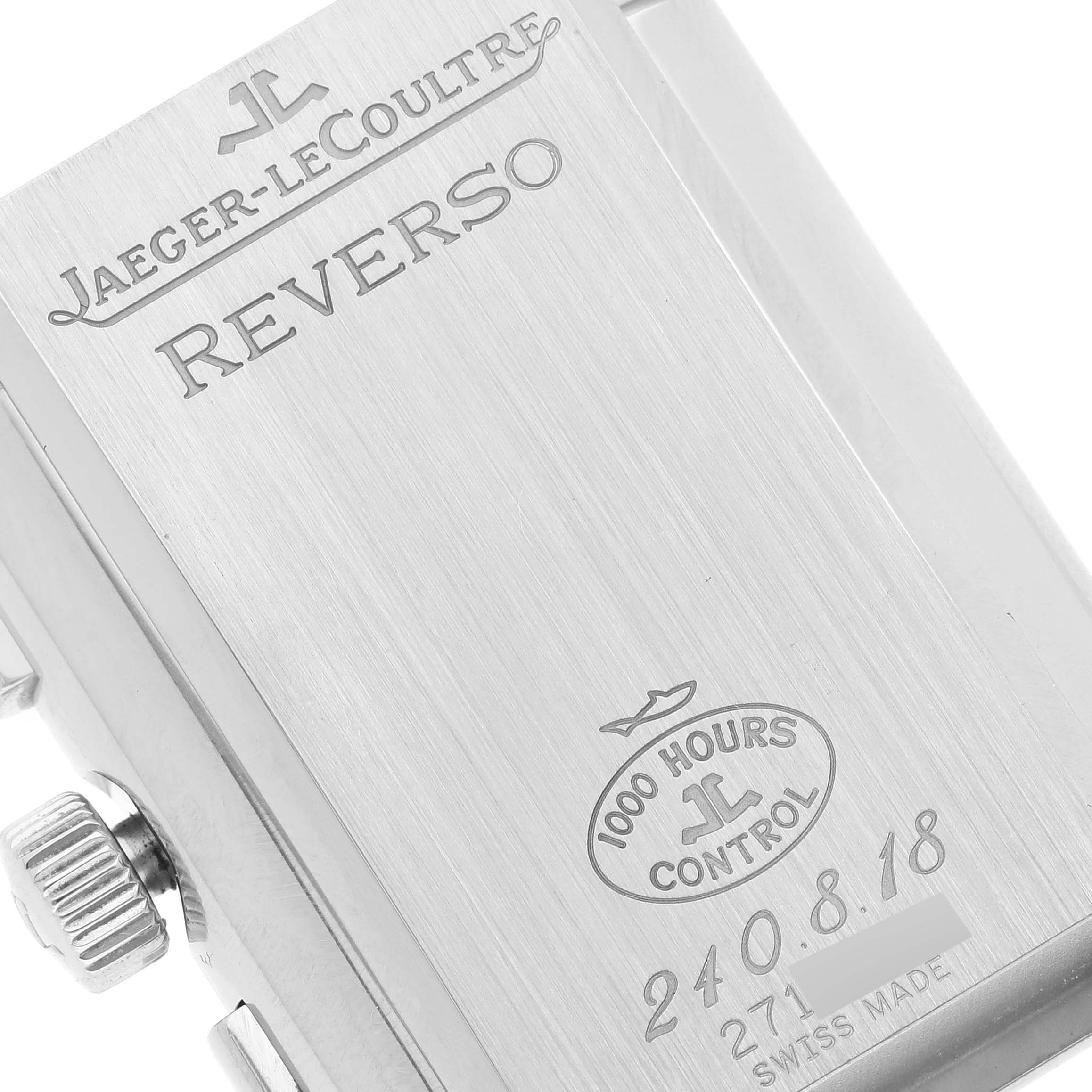 The image shows the back side of a Jaeger-LeCoultre Reverso watch, including engravings and part of the crown.