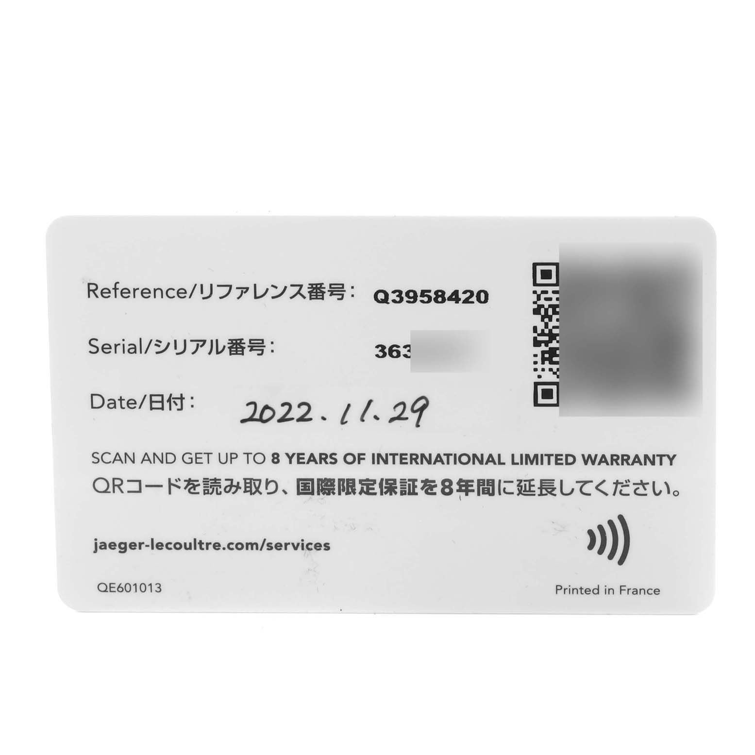 The image shows a warranty card for the Jaeger-LeCoultre Reverso model, including reference and serial numbers.