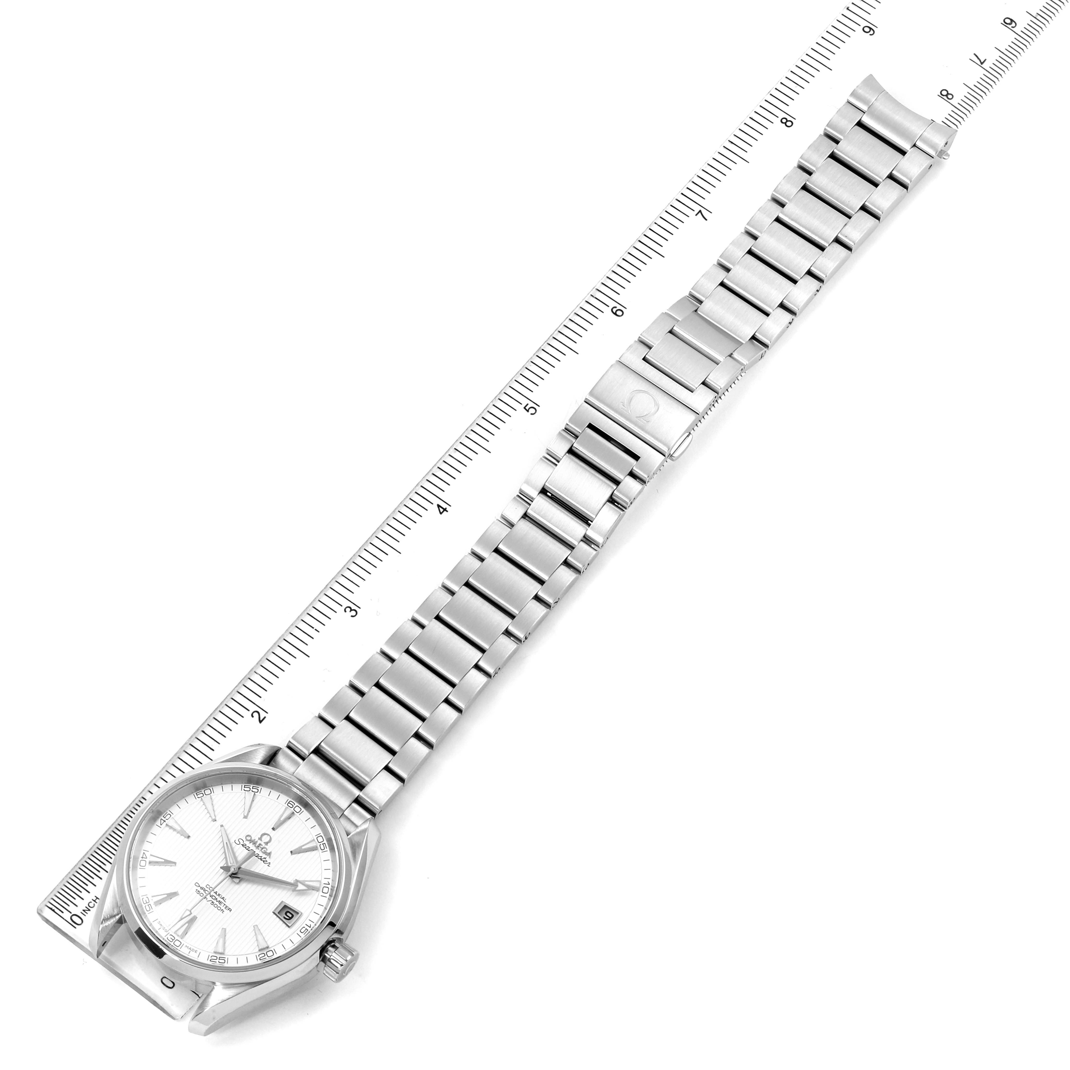 This image shows the Omega Aqua Terra 231.10.42.21.02.001 Men
s Stainless Steel Silver Dial 231.10.42.21.02.001 Men
s Stainless Steel Silver Dial watch from a top-down angle, highlighting its face, bracelet, and clasp alongside a ruler for scale.