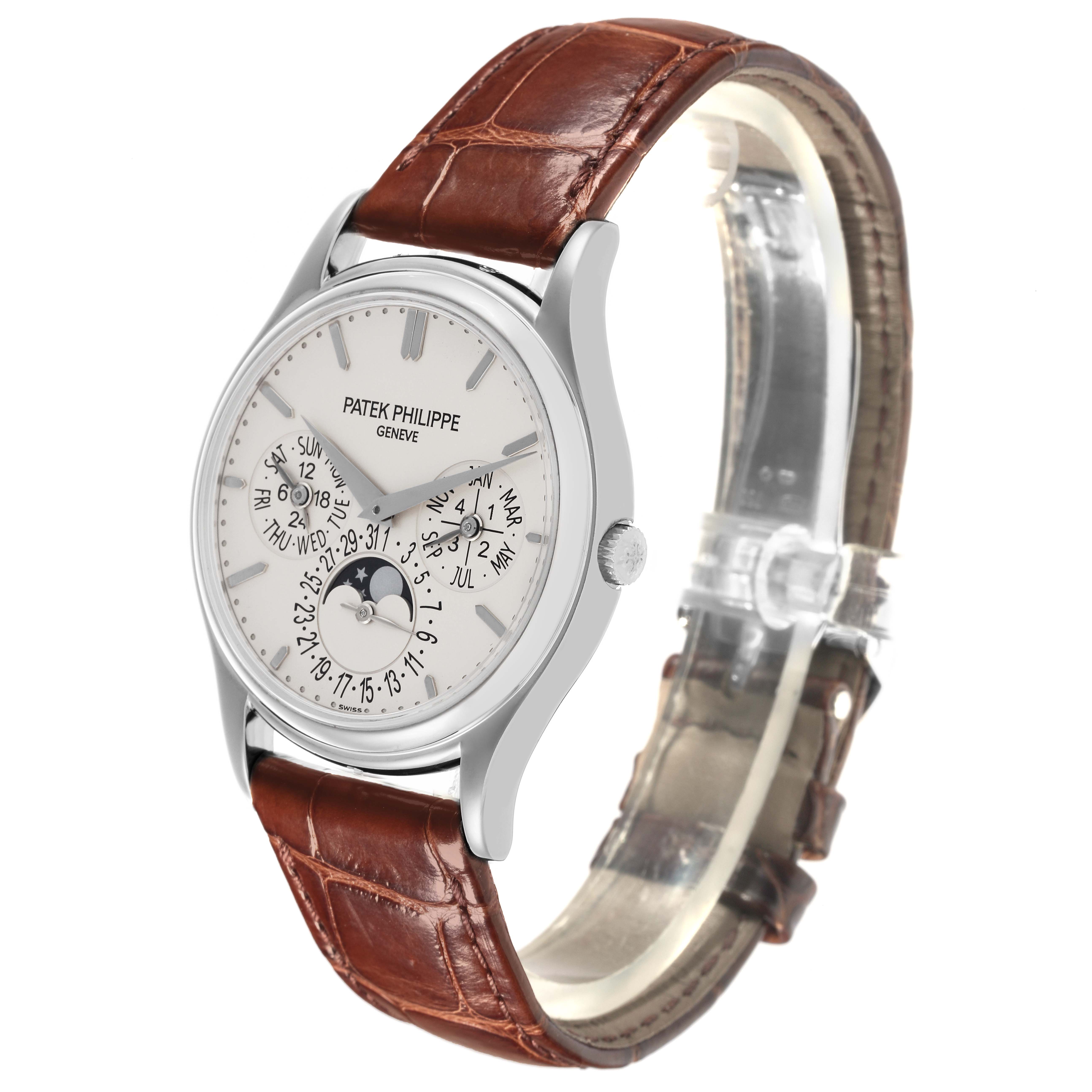 The Patek Philippe Complications 5140G-001 Men's White Gold Silver Dial 5140G-001 Men's White Gold Silver Dial watch is shown at a slight angle, displaying the dial, moon phase, and brown leather strap.