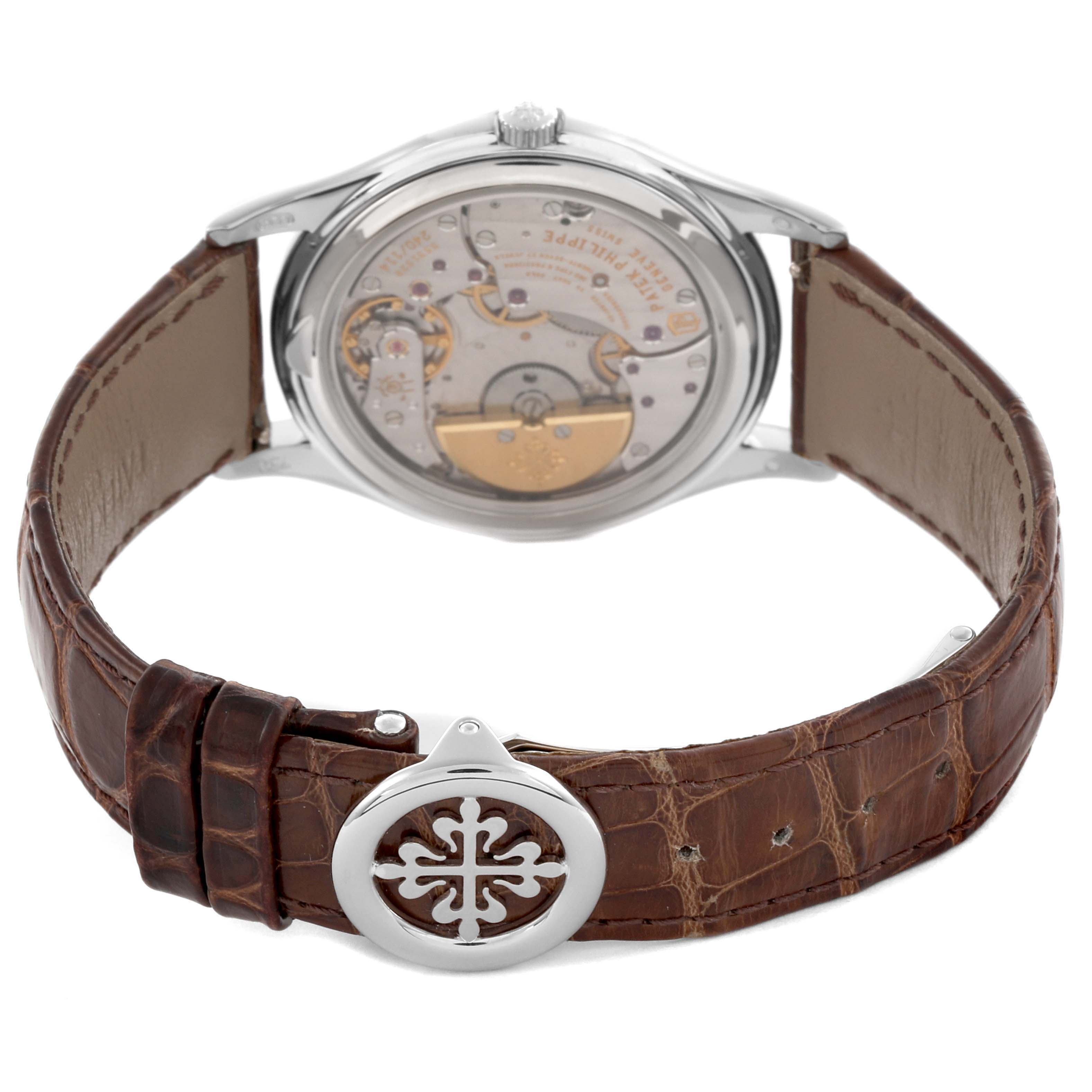 The Patek Philippe Complications 5140G-001 Men's White Gold Silver Dial 5140G-001 Men's White Gold Silver Dial watch is shown from the back, displaying the movement and leather strap with a branded clasp.