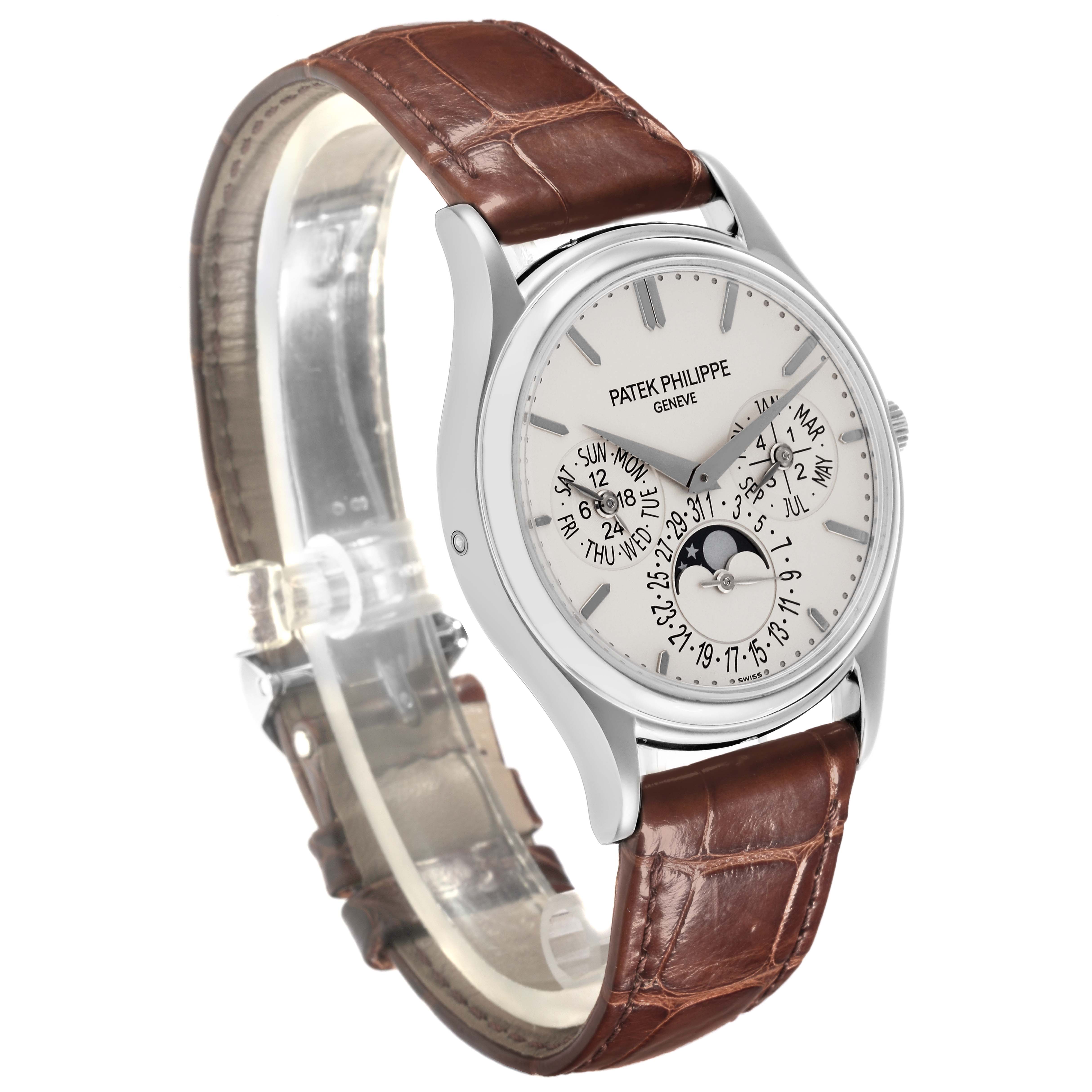 The Patek Philippe Complications 5140G-001 Men's White Gold Silver Dial 5140G-001 Men's White Gold Silver Dial watch is shown at a three-quarter angle, displaying the dial, crown, and leather strap.
