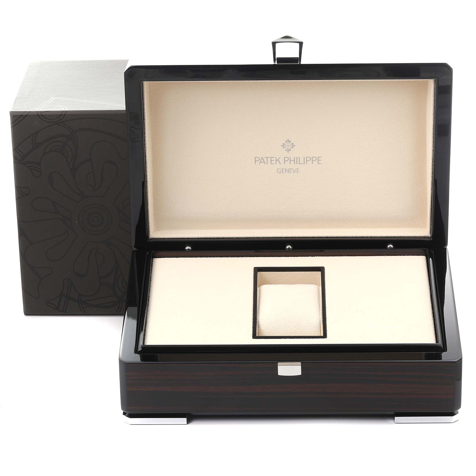 The image shows an open presentation box for a Patek Philippe Complications 5140G-001 Men's White Gold Silver Dial 5140G-001 Men's White Gold Silver Dial watch, showcasing the interior and logo.