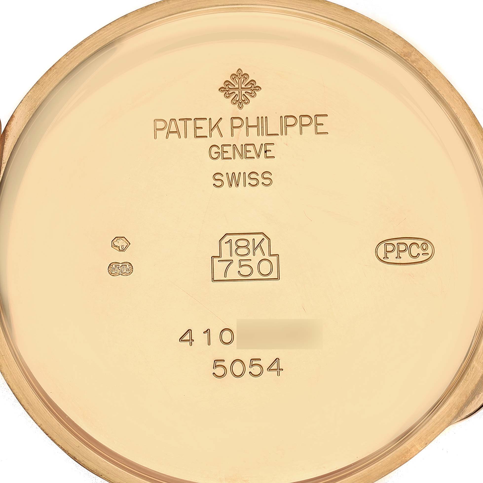 The image shows the inside case back of a Patek Philippe Complications 5054 Men's Yellow Gold White Dial watch, highlighting engravings and hallmarks.