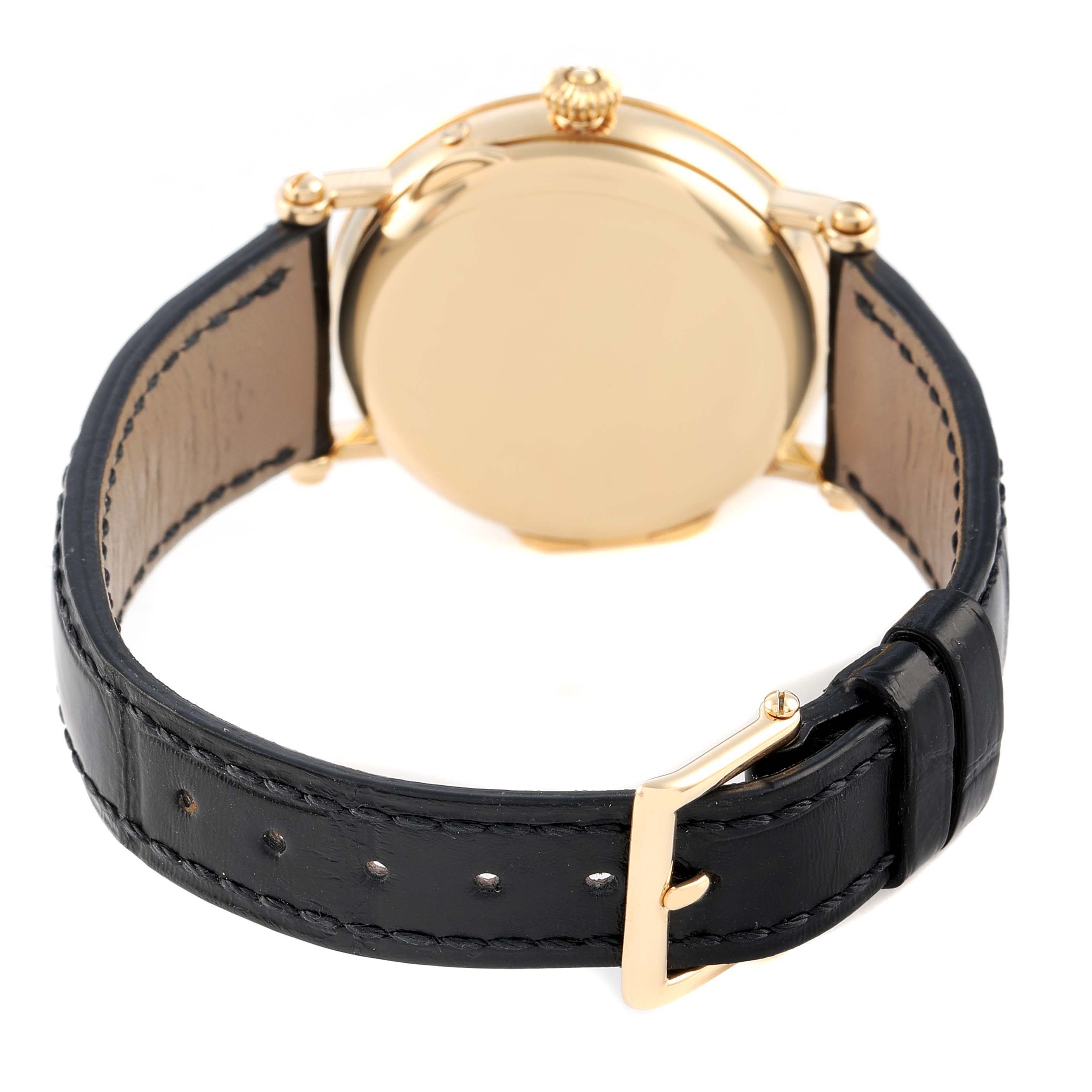 The image shows the back of the Patek Philippe Complications 5054 Men's Yellow Gold White Dial watch, highlighting the case back and black leather strap with buckle.