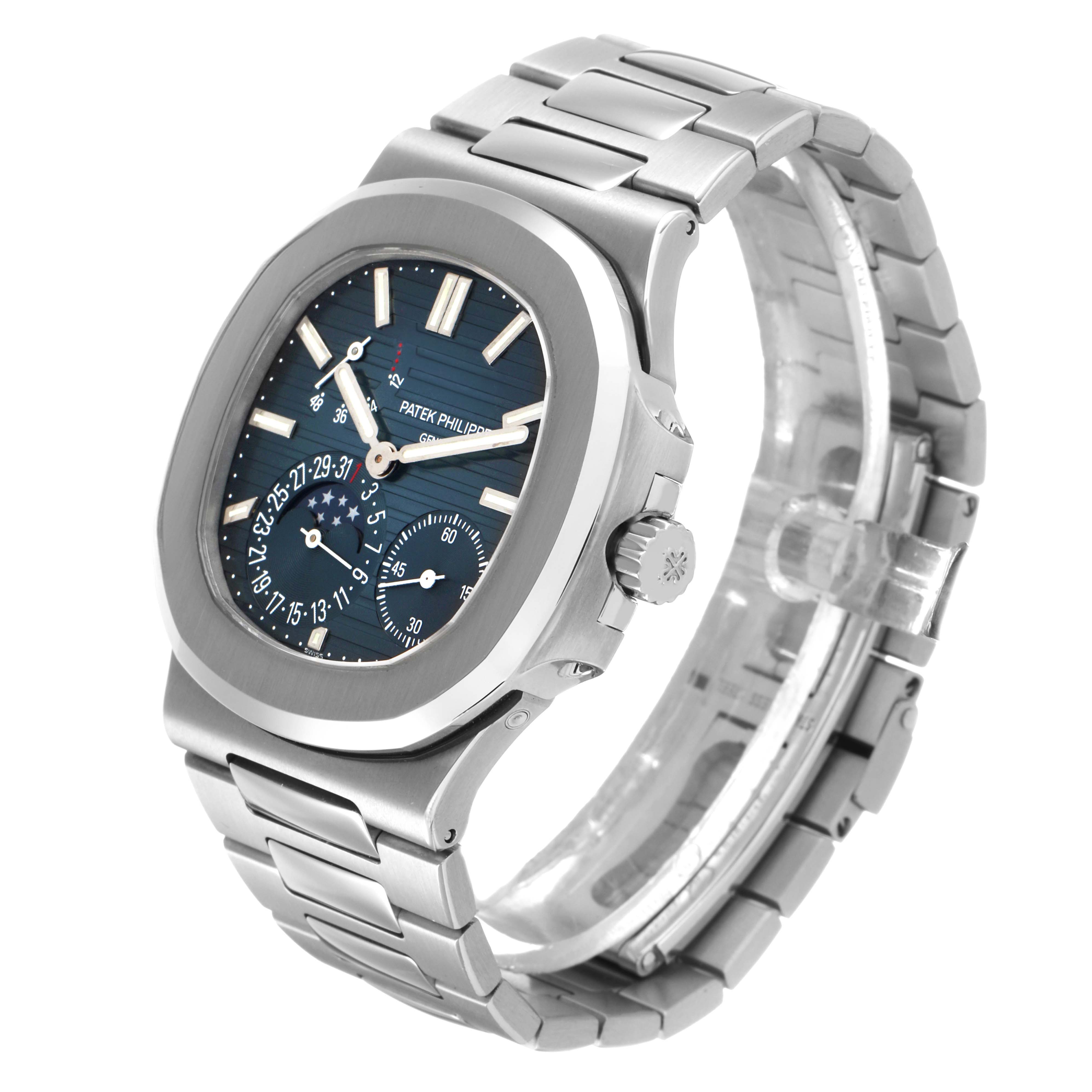 The Patek Philippe Nautilus 5712/1A-001 Men's Stainless Steel Blue Dial watch is shown at a three-quarter angle, displaying the face, bezel, and bracelet.