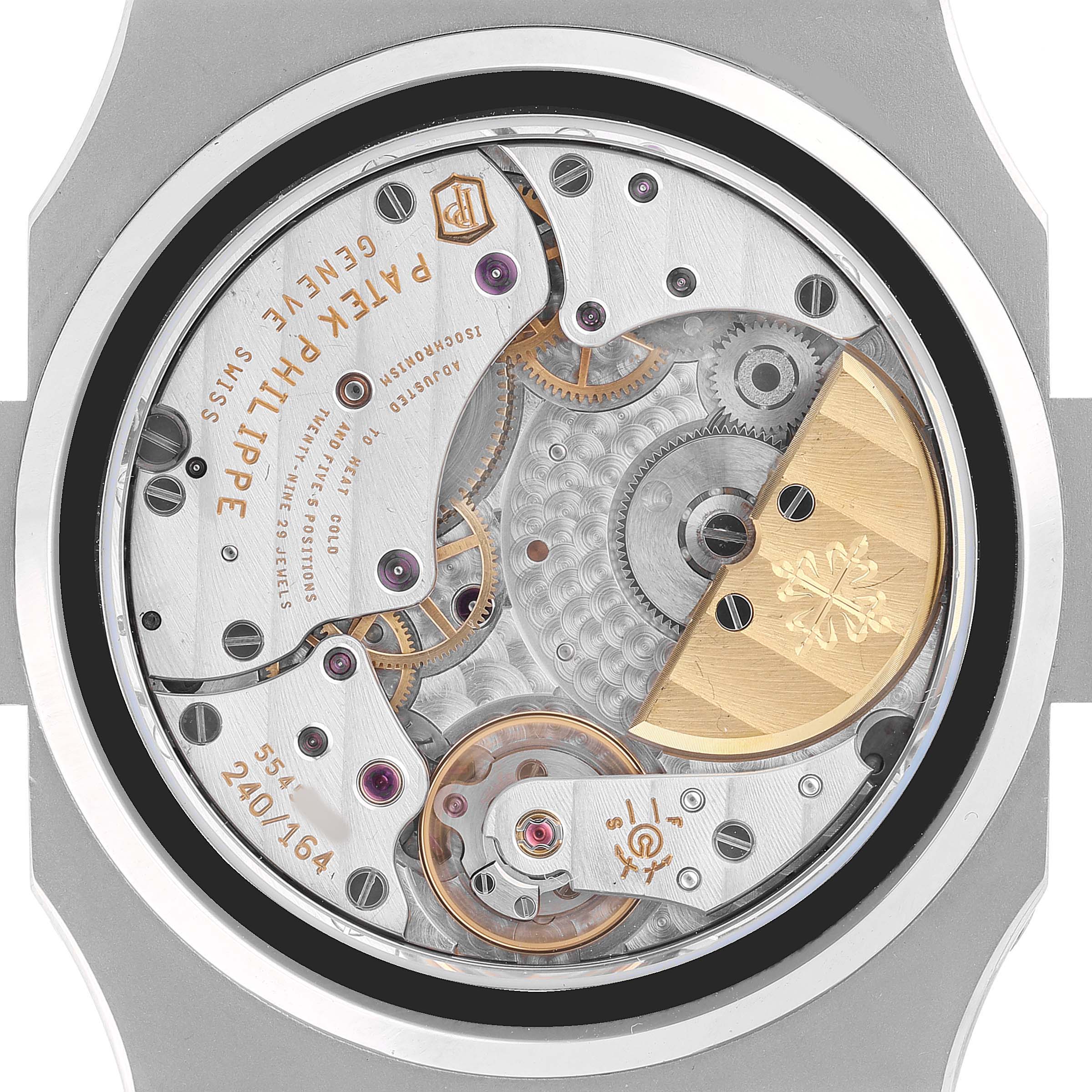 The image shows the movement of a Patek Philippe Nautilus 5712/1A-001 Men's Stainless Steel Blue Dial watch from a back view, highlighting its intricate mechanics.