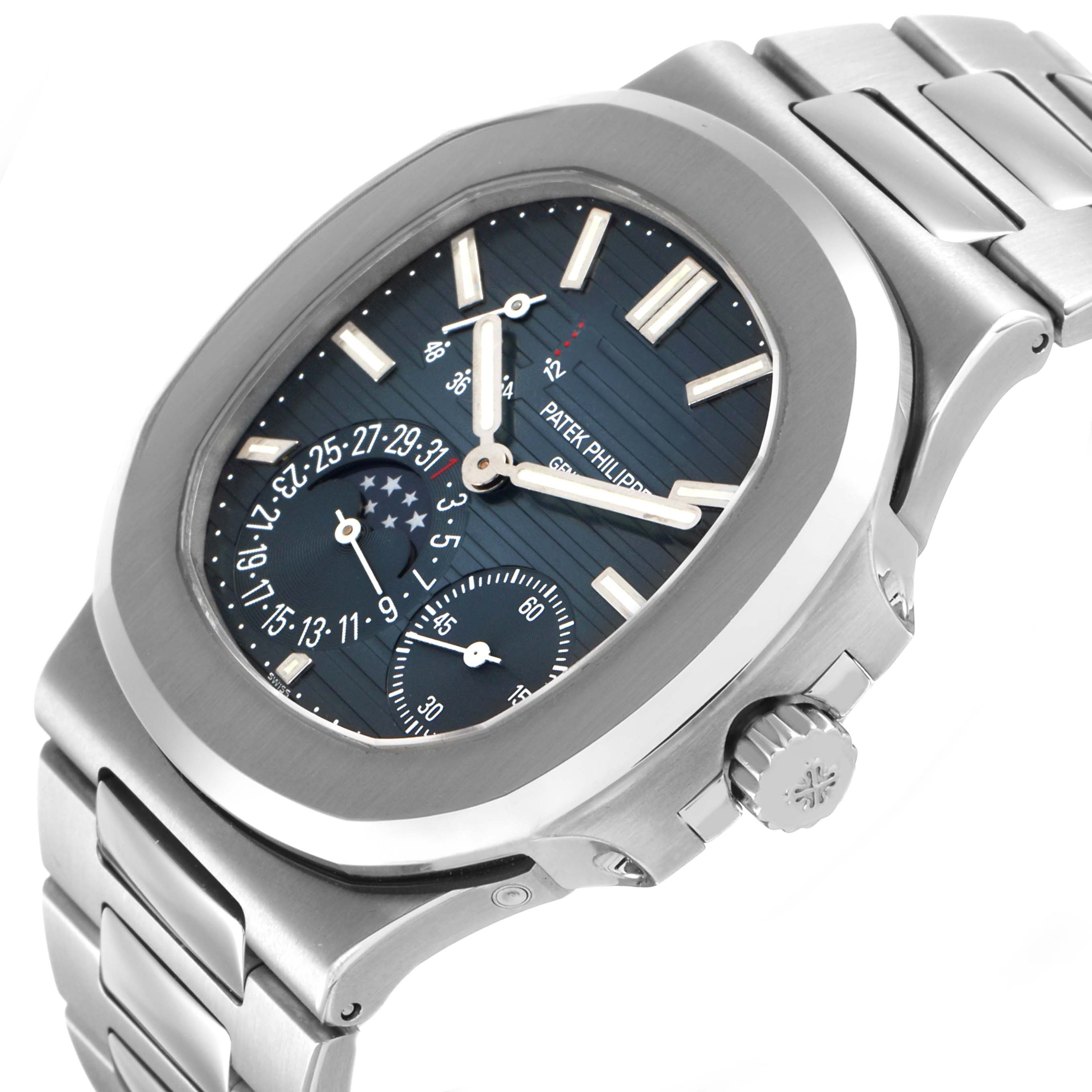 The Patek Philippe Nautilus 5712/1A-001 Men's Stainless Steel Blue Dial watch is shown at an angle highlighting the face, crown, and part of the metal bracelet.