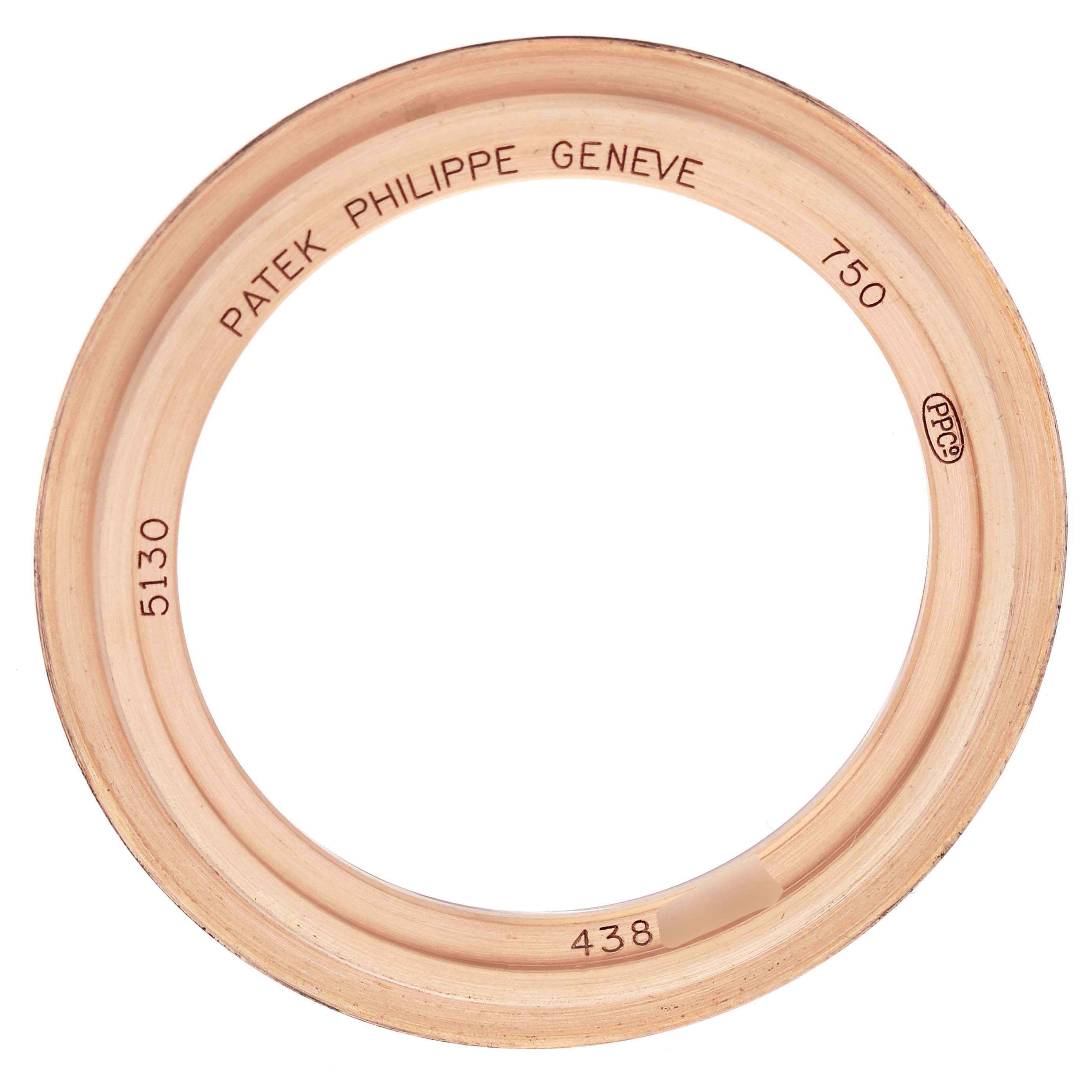 The image shows a gold bezel from the Patek Philippe Complications 5130R-001 Men's Rose Gold Silver Dial 5130R-001 Men's Rose Gold Silver Dial model, viewed from above.