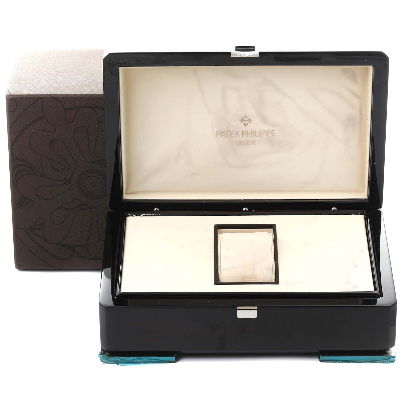 The image shows an open Patek Philippe Complications 5130R-001 Men's Rose Gold Silver Dial 5130R-001 Men's Rose Gold Silver Dial watch box from a front angle, revealing the interior lining and compartment.