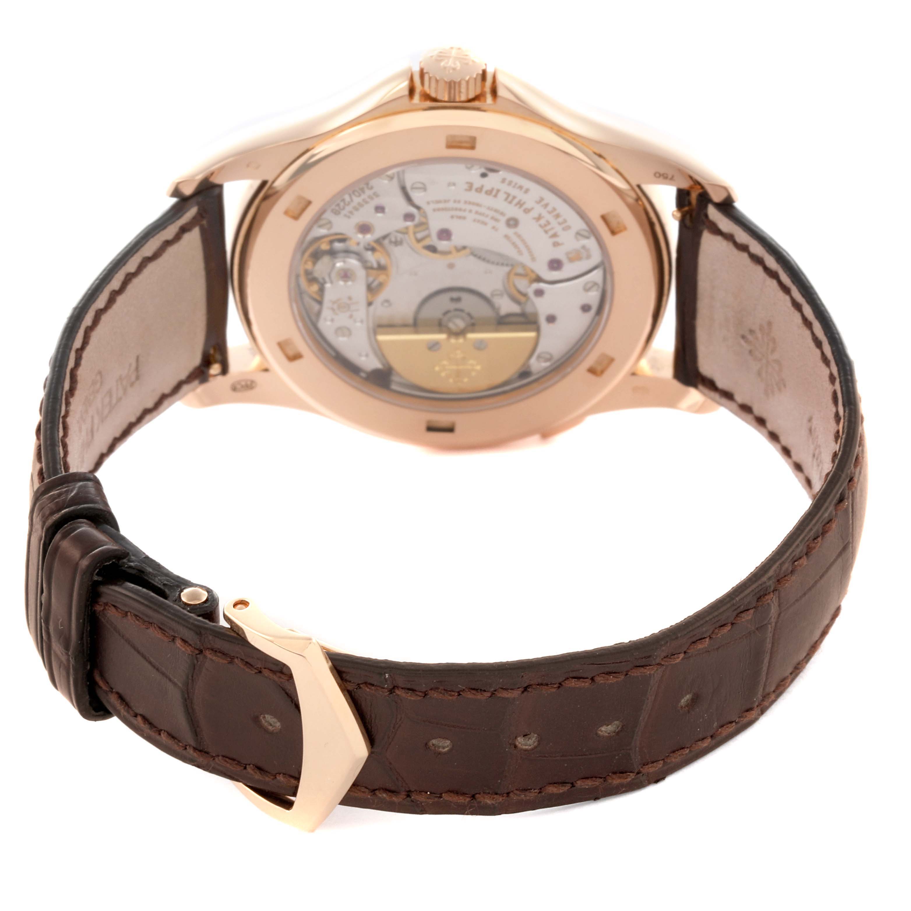 The image shows the back of a Patek Philippe Complications 5130R-001 Men's Rose Gold Silver Dial 5130R-001 Men's Rose Gold Silver Dial watch, highlighting the movement and brown leather strap.