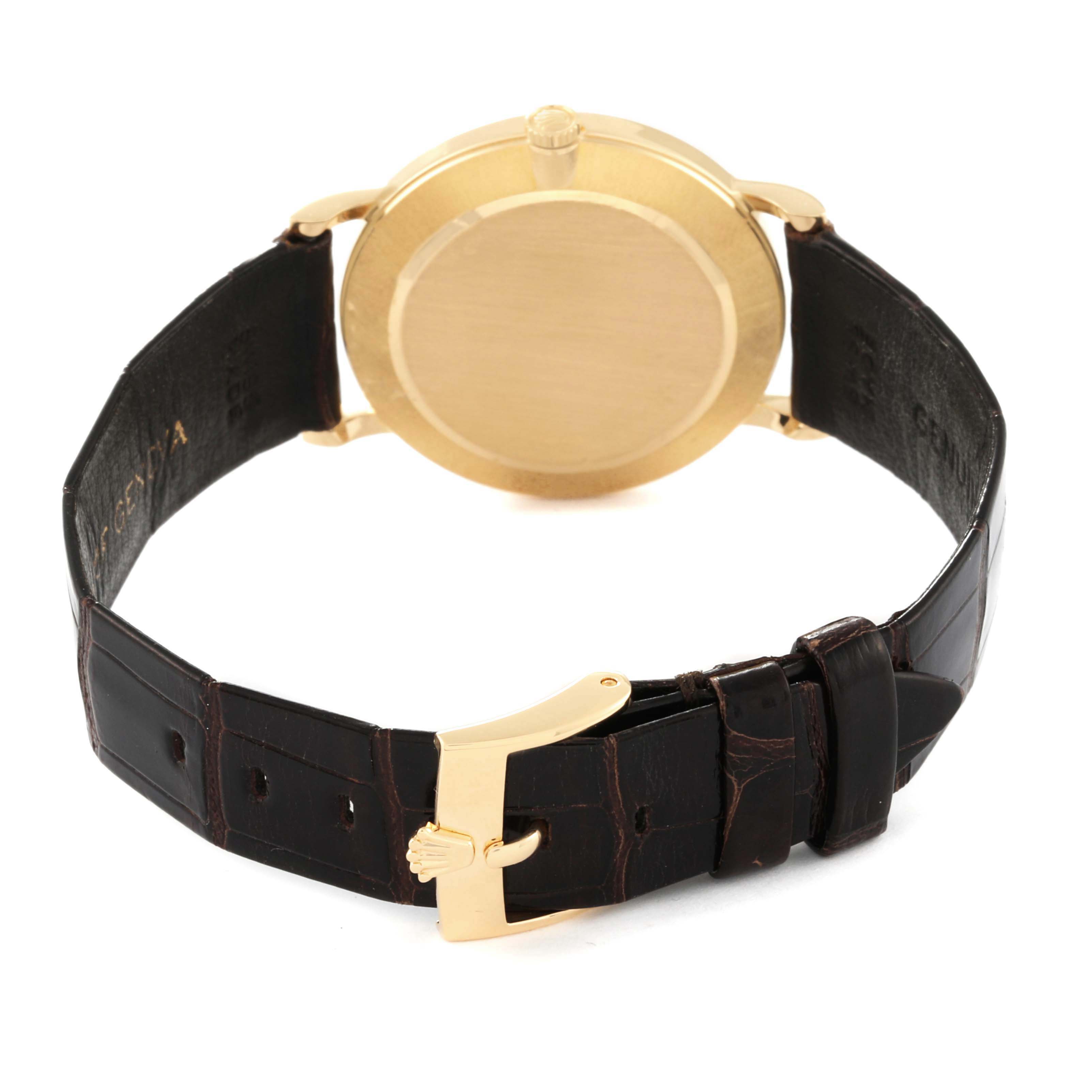 The image shows the back of a Rolex Cellini 5112 Men's Yellow Gold Beige Dial 5112 Men's Yellow Gold Beige Dial watch and its leather strap with a gold buckle.