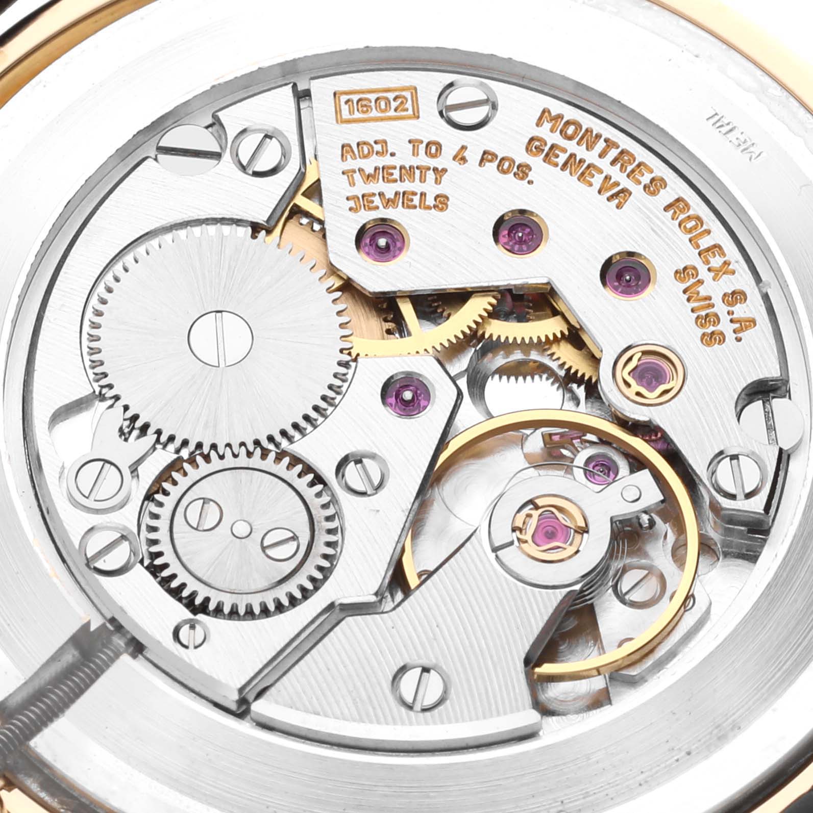 This image shows the intricate internal mechanics of a Rolex Cellini 5112 Men's Yellow Gold Beige Dial 5112 Men's Yellow Gold Beige Dial watch, highlighting its gears and jewels from a close-up angle.