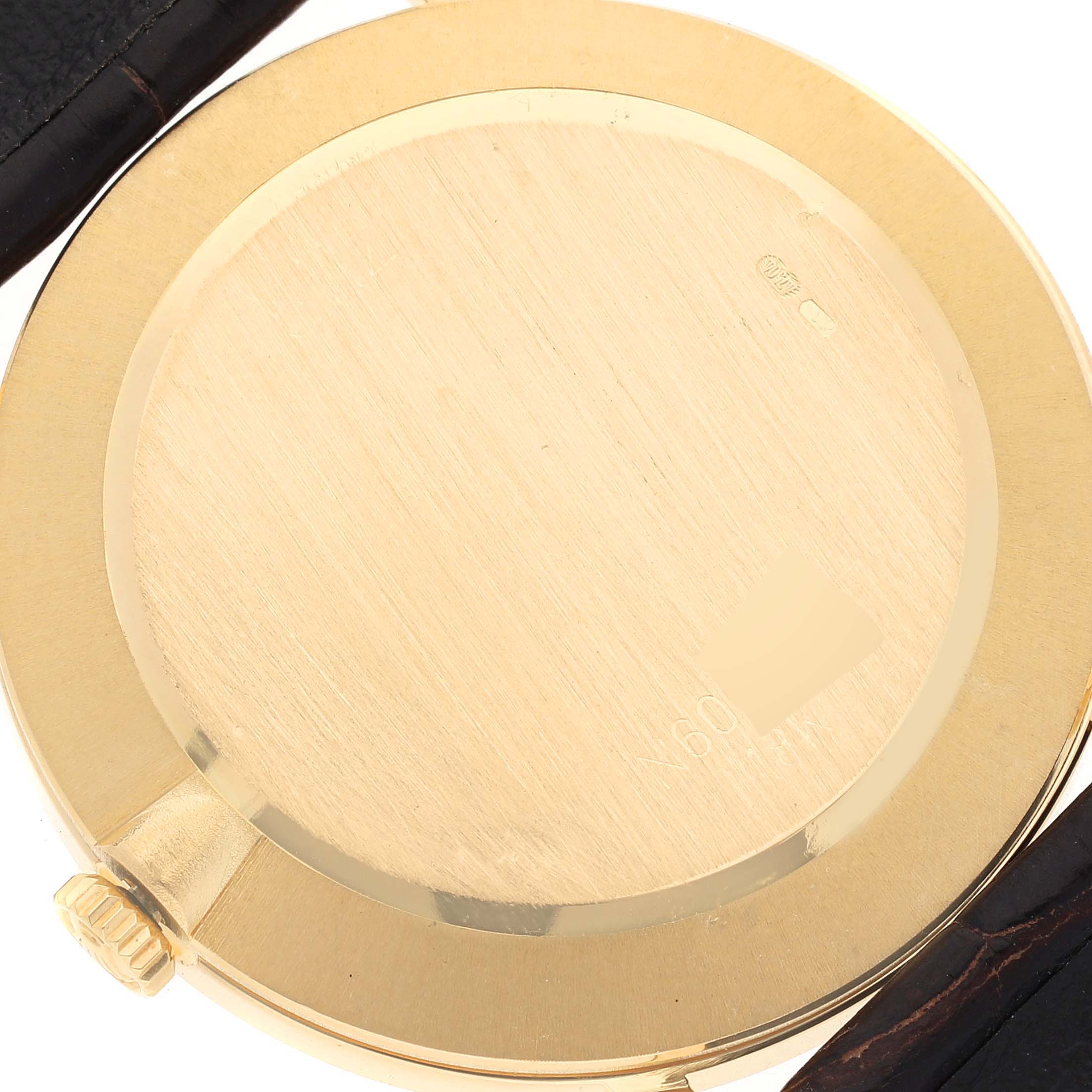 This image shows the back case and part of the strap of a Rolex Cellini 5112 Men's Yellow Gold Beige Dial 5112 Men's Yellow Gold Beige Dial watch.