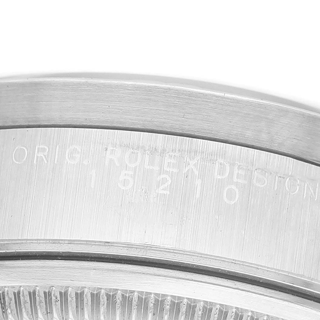 The image shows a close-up of the bezel and case side engraving on a Rolex Date 15210 Men's Stainless Steel Black Dial model watch.