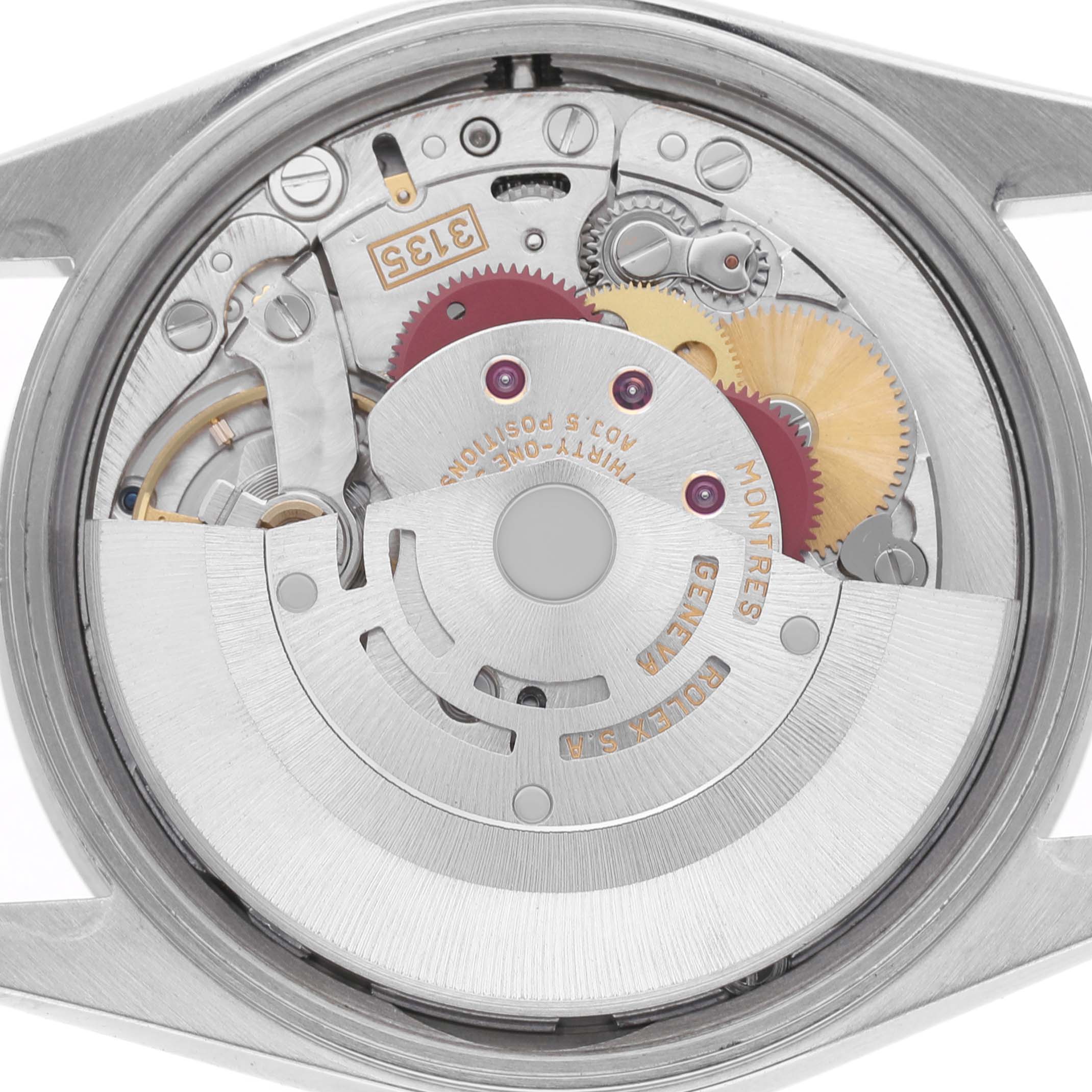 The image shows the movement and internal mechanics of a Rolex Date 15210 Men's Stainless Steel Black Dial model watch from the back.