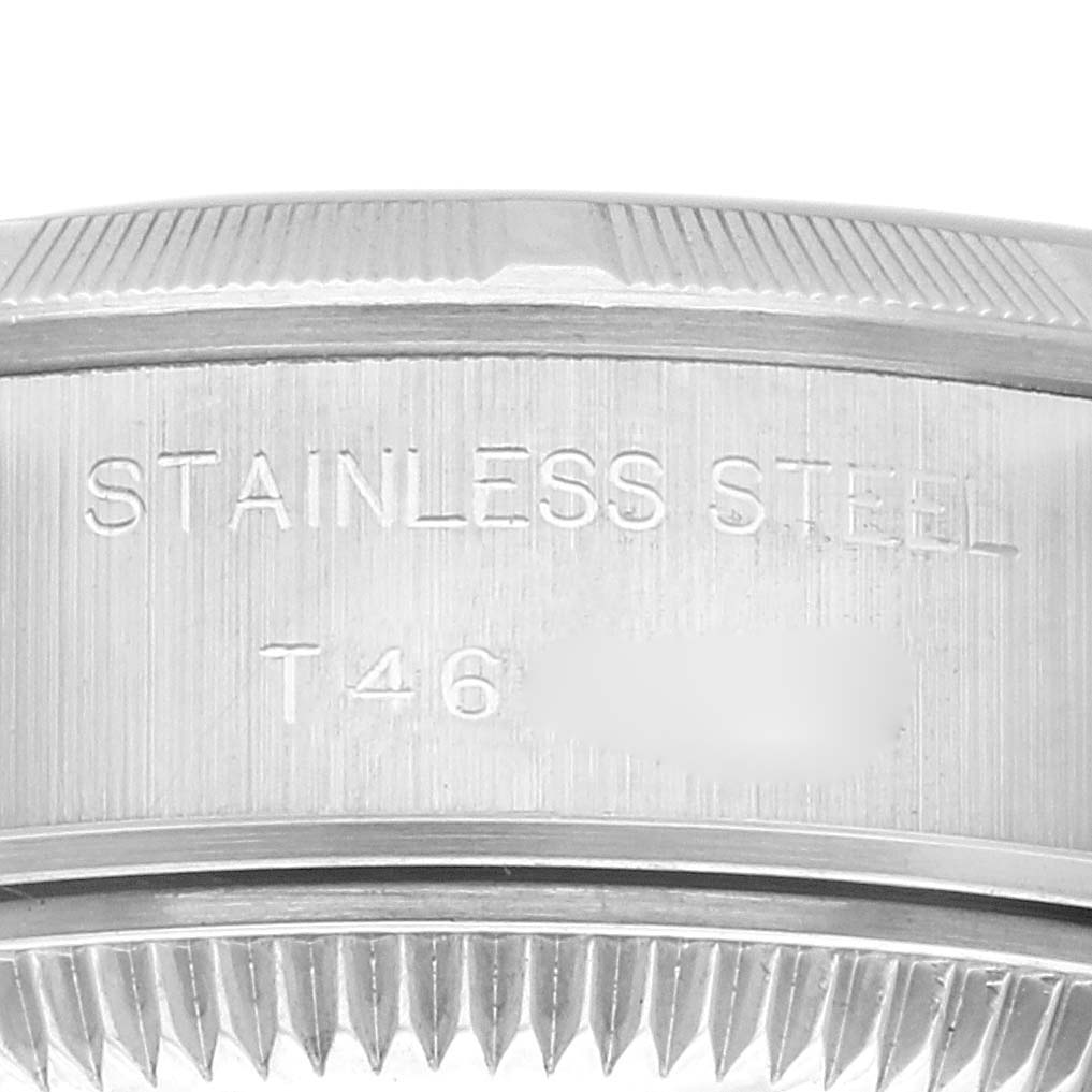 This image shows a close-up of the bezel and case side of a Rolex Date 69190 Women's Stainless Steel Blue Dial 69190 Women's Stainless Steel Blue Dial model, highlighting "STAINLESS STEEL" engraving.