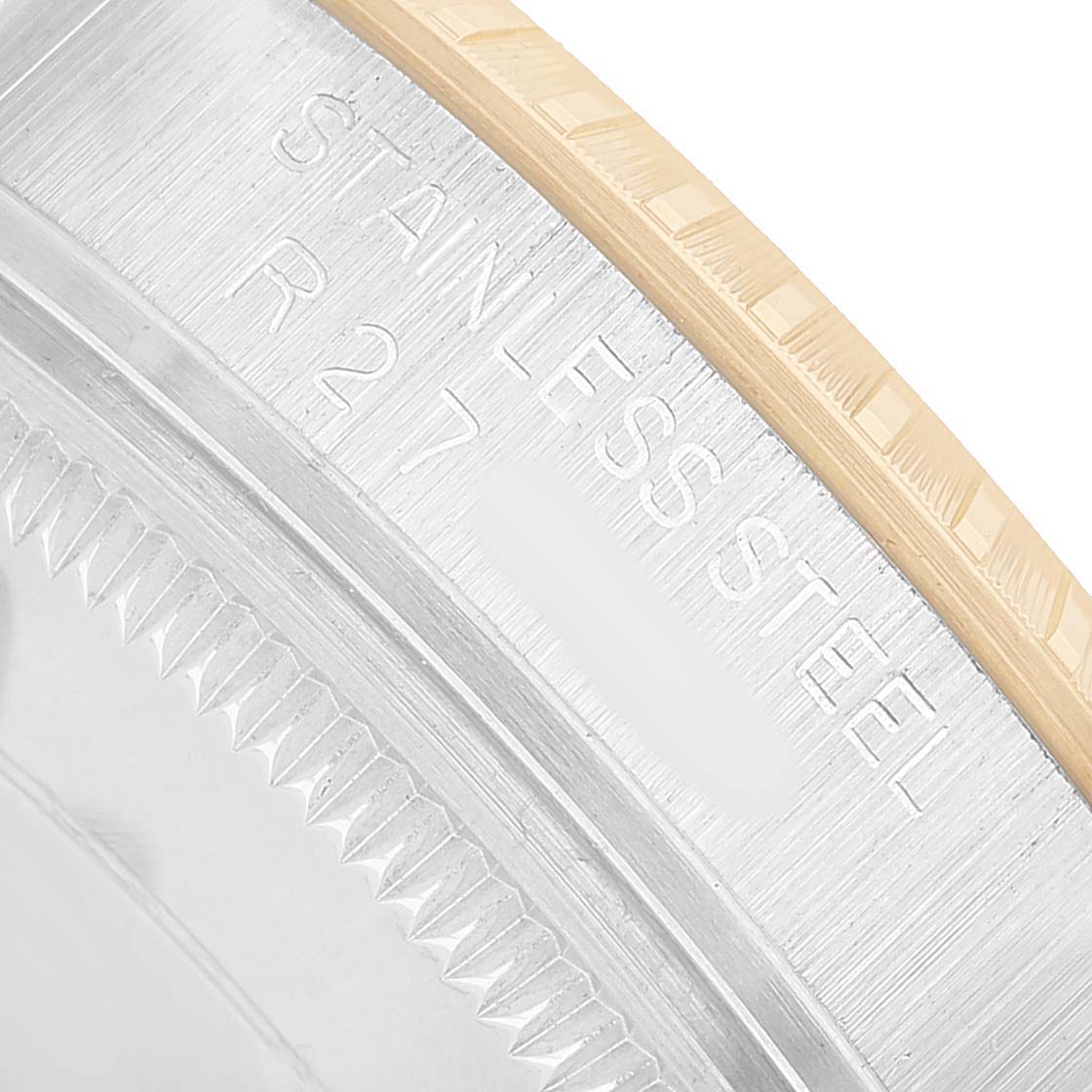 The image shows a close-up of the bezel and case edge of a Rolex Date 15053 Men's Steel and Gold (two tone) Champagne Dial model, highlighting the stainless steel text engraving.