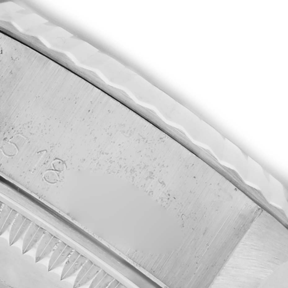 The image shows a close-up of the bezel and edge of the case of a Rolex Date 6917 Women's Stainless Steel Silver Dial 6917 Women's Stainless Steel Silver Dial watch, highlighting its fluted design.