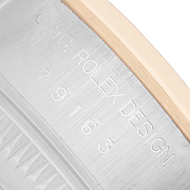 The image shows a close-up of the engraved side of a Rolex Datejust 79163 Women's Steel and Gold (two tone) Silver Dial, highlighting the case and bezel details.