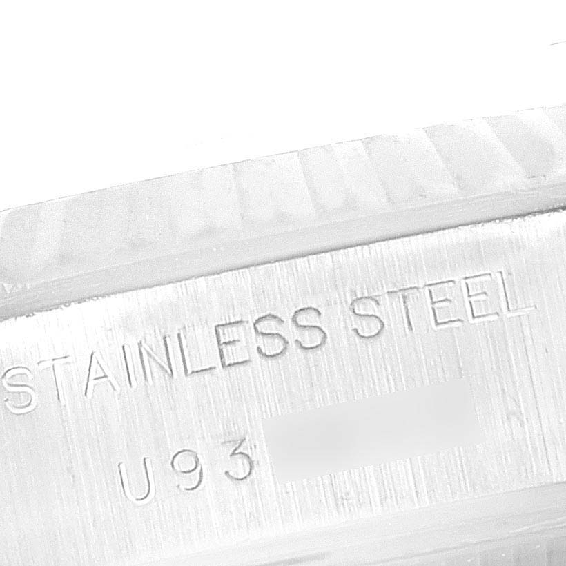 The image shows a close-up of the engraved serial number and "stainless steel" text on a Rolex Datejust 69174 Women's Stainless Steel Pink Dial 69174 Women's Stainless Steel Pink Dial watch.