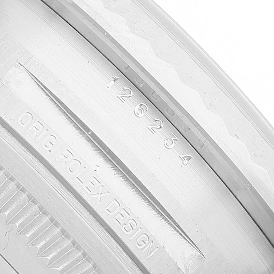 The image shows a close-up of the Rolex Datejust 126234 Men's Steel and Gold (two tone) Black Dial's case side, displaying the engravings "ORIG ROLEX DESIGN" and a serial number.