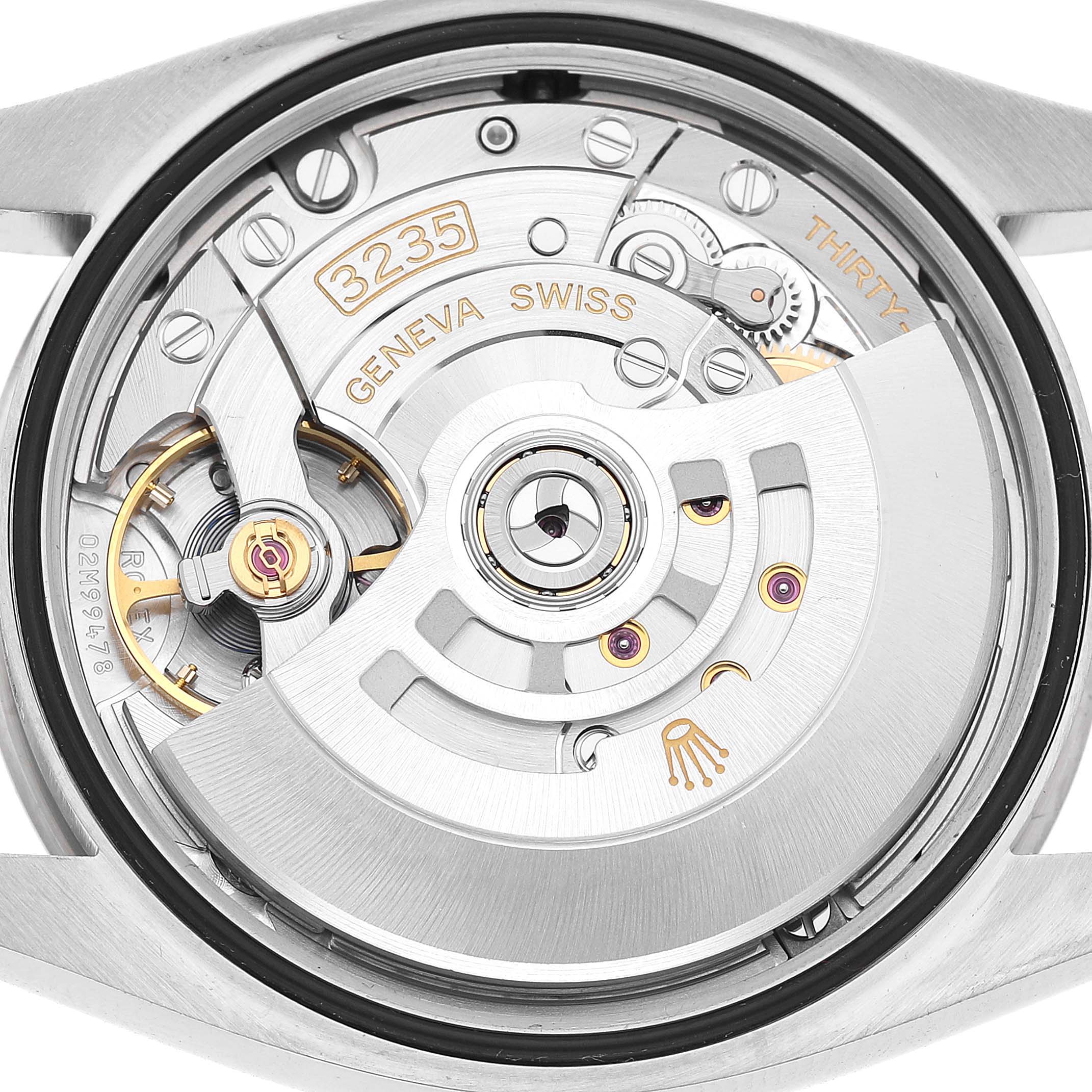 The image shows the movement of a Rolex Datejust 126234 Men's Steel and Gold (two tone) Black Dial, highlighting intricate gears and the rotor from the back view.