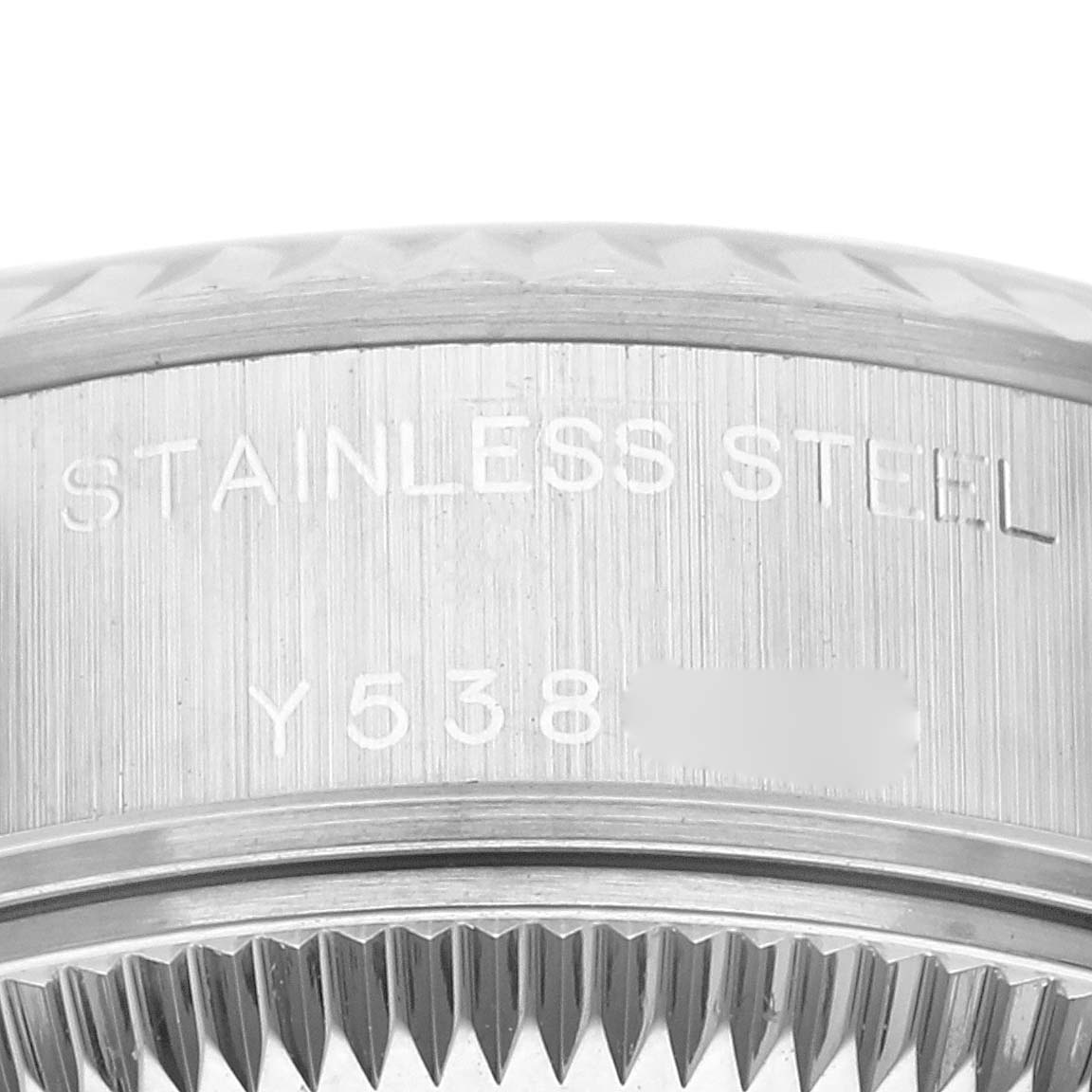This close-up image shows the side engraving and fluted bezel of a Rolex Datejust 79174 Women's Stainless Steel Blue Dial 79174 Women's Stainless Steel Blue Dial watch, highlighting its stainless steel construction.