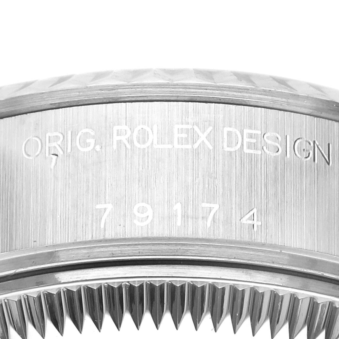 This close-up image shows the side of the Rolex Datejust 79174 Women's Stainless Steel Blue Dial 79174 Women's Stainless Steel Blue Dial watch case with engravings and part of the fluted bezel.