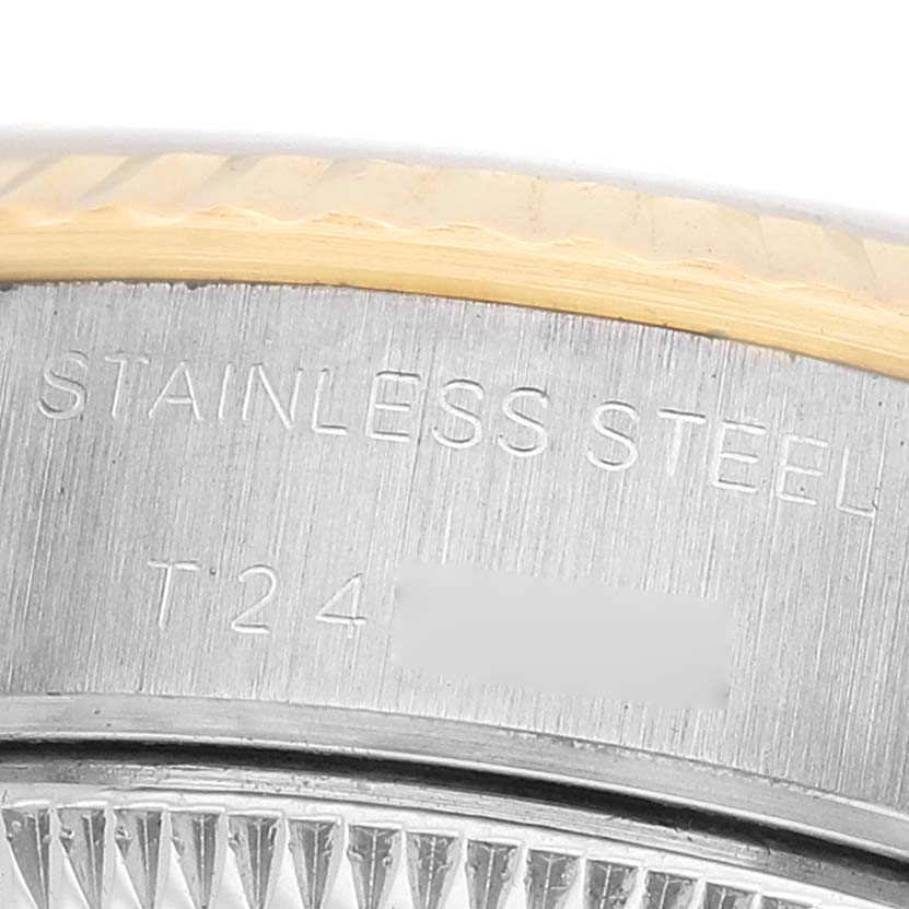 The image shows a close-up of the side of a Rolex Datejust 69173 Women's Steel and Gold (two tone) Champagne Dial, highlighting the stainless steel part and engraved details.