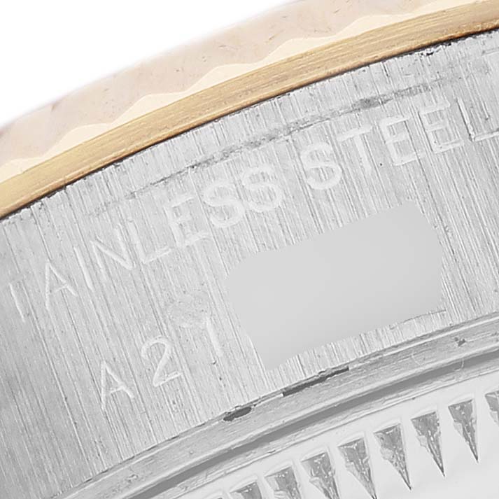 The image shows a close-up of the side of a Rolex Datejust 79173 Women's Steel and Gold (two tone) Champagne Dial watch case, highlighting the bezel edge and engraved text.