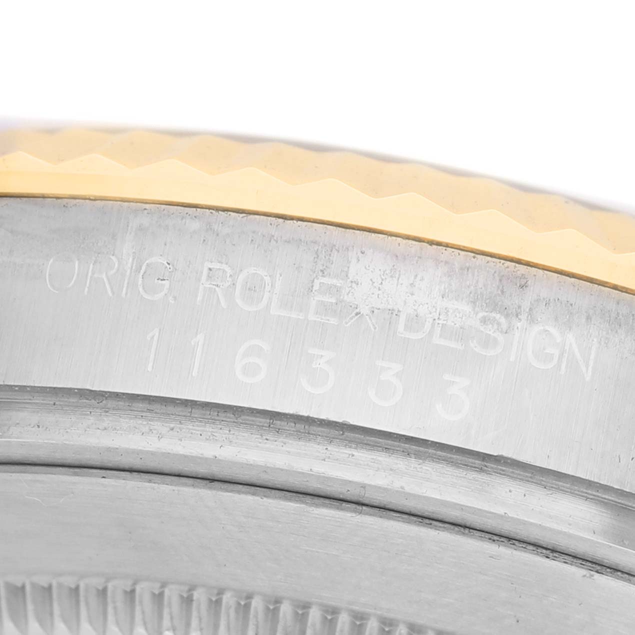 The image shows a close-up of the Rolex Datejust 41 116333 Men's Steel and Gold (two tone) Champagne Dial model's etched case, focusing on the bezel and case number.