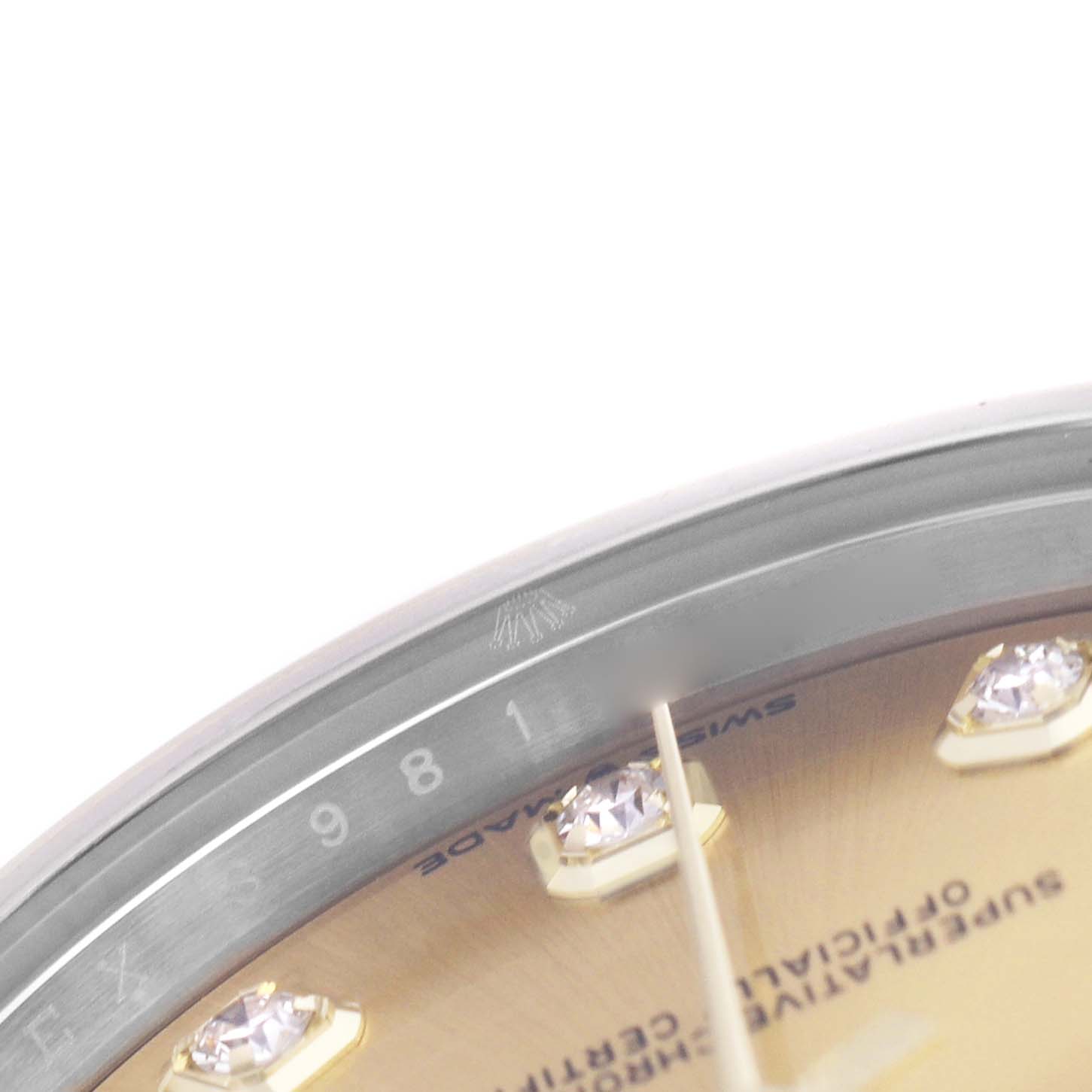 The image shows a partial close-up of a Rolex Mid-Size 278273 Women's Steel and Gold (two tone) Champagne Dial watch dial, highlighting the bezel and diamond hour markers.