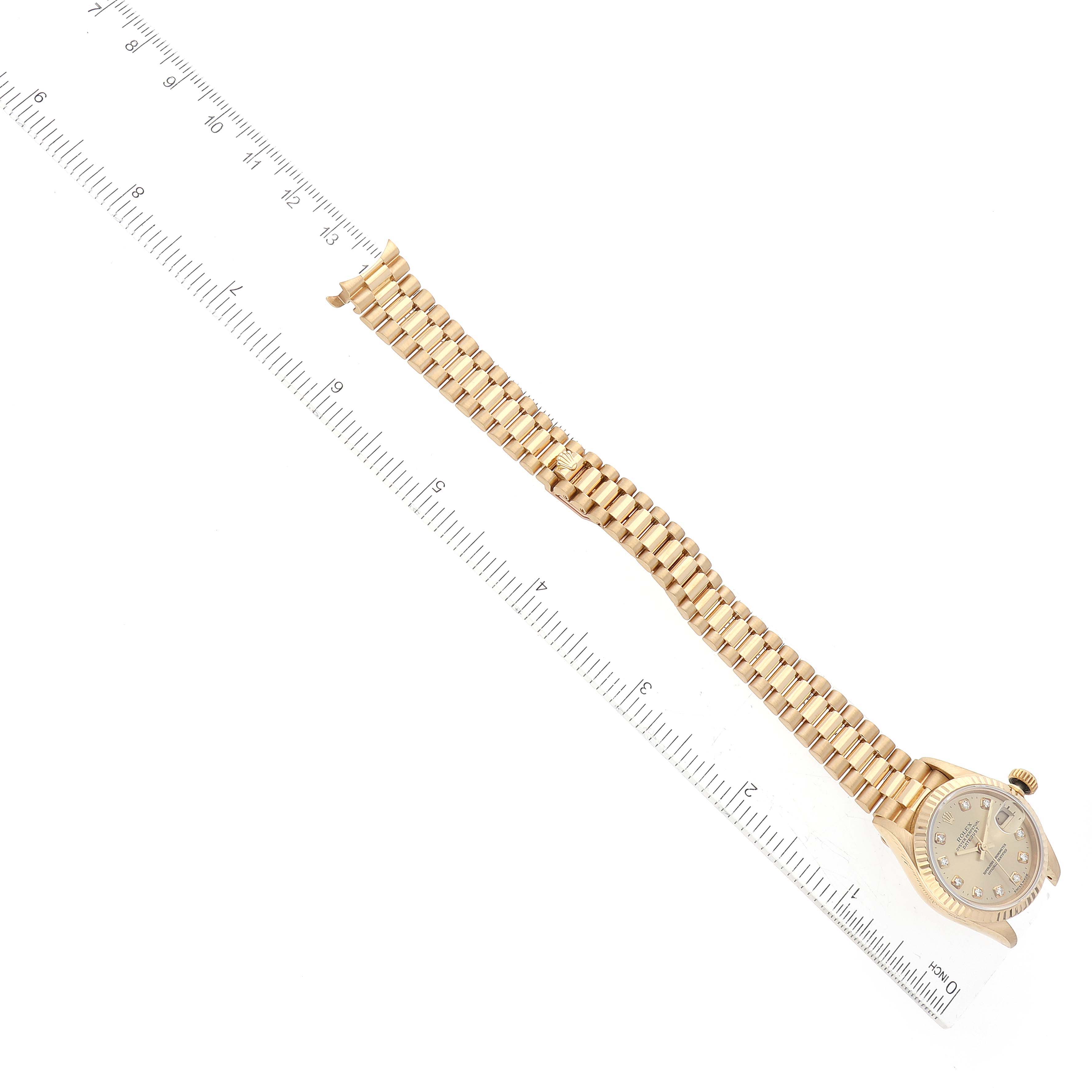The image shows a Rolex President 69178 Women's Yellow Gold Champagne Dial 69178 Women's Yellow Gold Champagne Dial model watch laid diagonally, displaying its face, bracelet, and a ruler for scale.