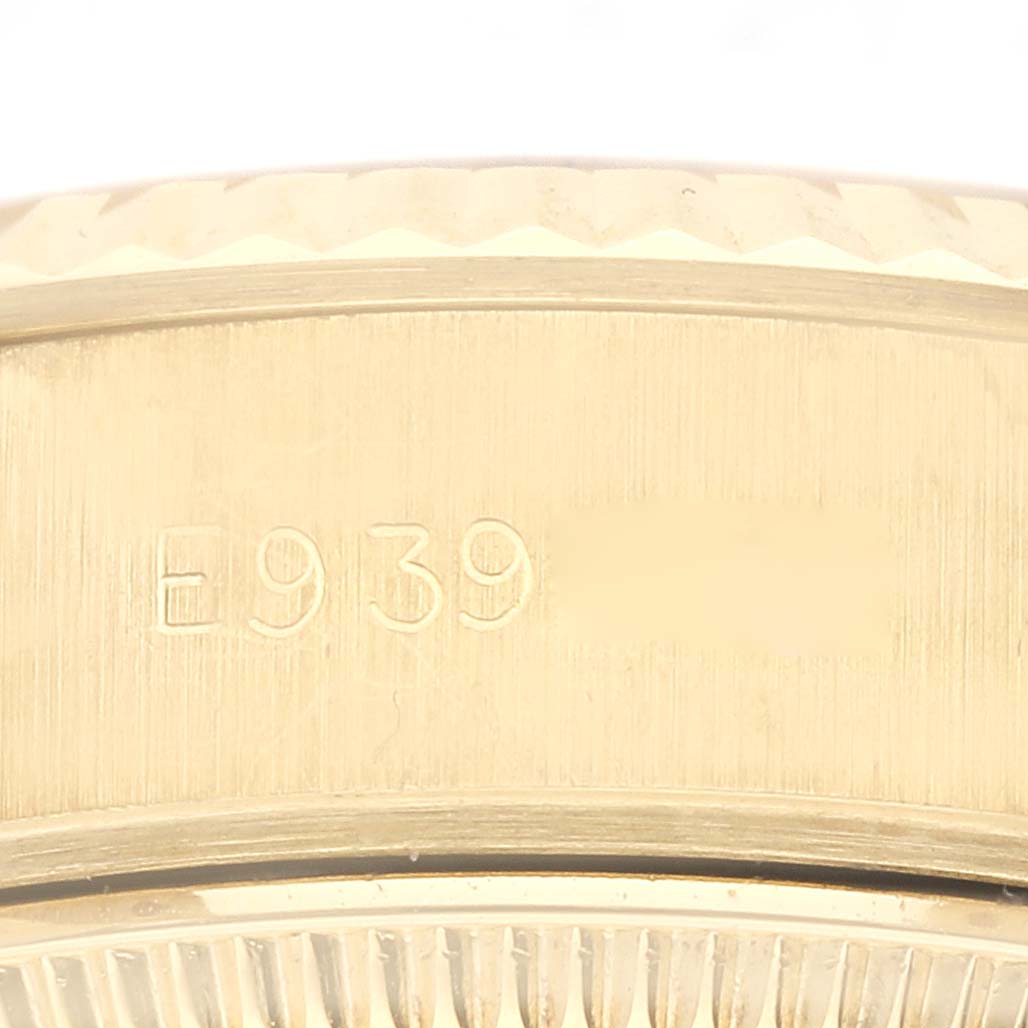This close-up image shows the side of the case and bezel of a Rolex President 69178 Women's Yellow Gold Champagne Dial 69178 Women's Yellow Gold Champagne Dial model watch, highlighting the engraved serial number.
