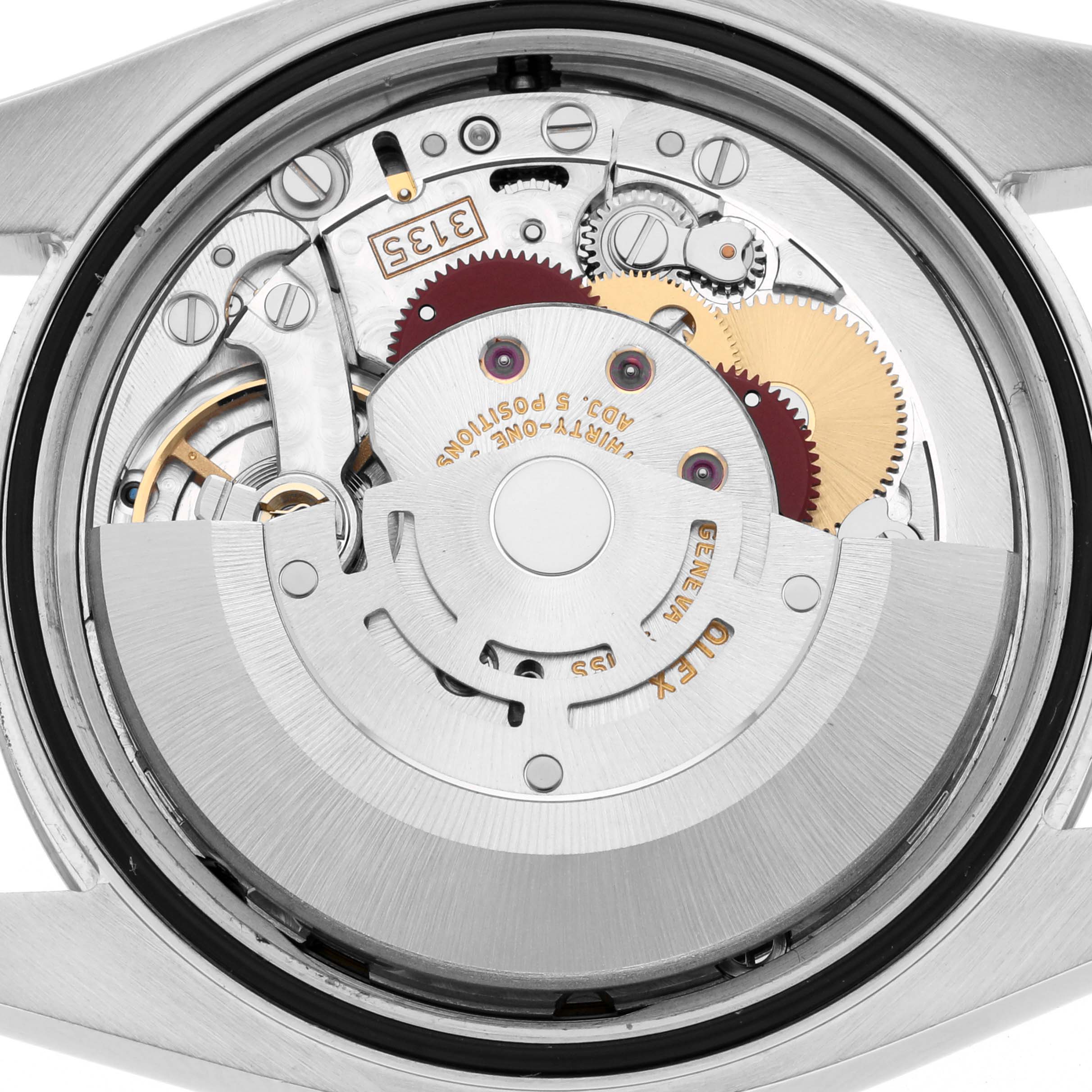 The image shows the movement components of a Rolex Datejust 116234 Men's Stainless Steel Black Dial 116234 Men's Stainless Steel Black Dial from a reverse angle, highlighting gears and the rotor.