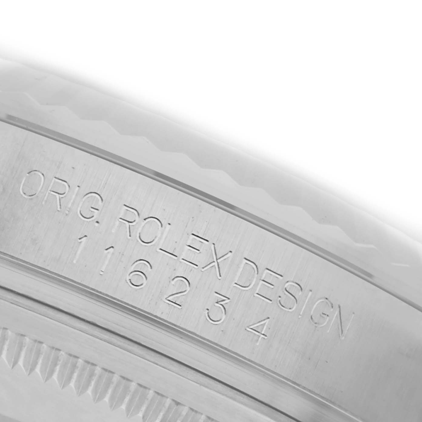 The image shows a close-up of the side engraving on a Rolex Datejust 116234 Men's Stainless Steel Black Dial 116234 Men's Stainless Steel Black Dial watch case, featuring the model and design details.