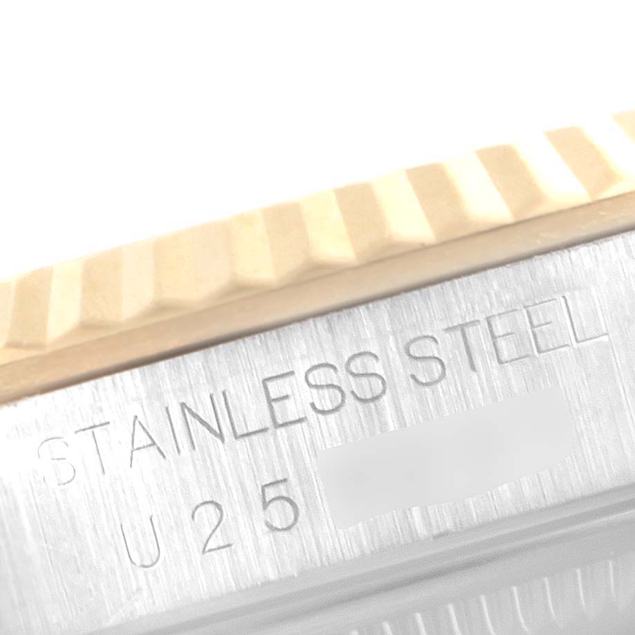 This image shows a close-up of the bezel and case side of a Rolex Datejust 16233 Men's Steel and Gold (two tone) Champagne Dial 16233 Men's Steel and Gold (two tone) Champagne Dial watch, highlighting the "STAINLESS STEEL" engraving.