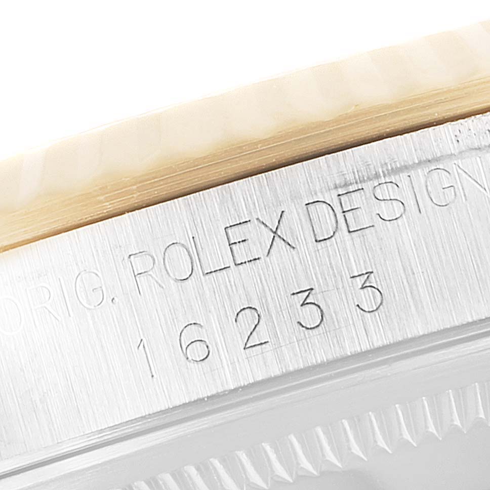 The image shows the side view of a Rolex Datejust 16233 Men's Steel and Gold (two tone) Blue Dial 16233 Men's Steel and Gold (two tone) Blue Dial watch, specifically focusing on its engraved model number and design marking.