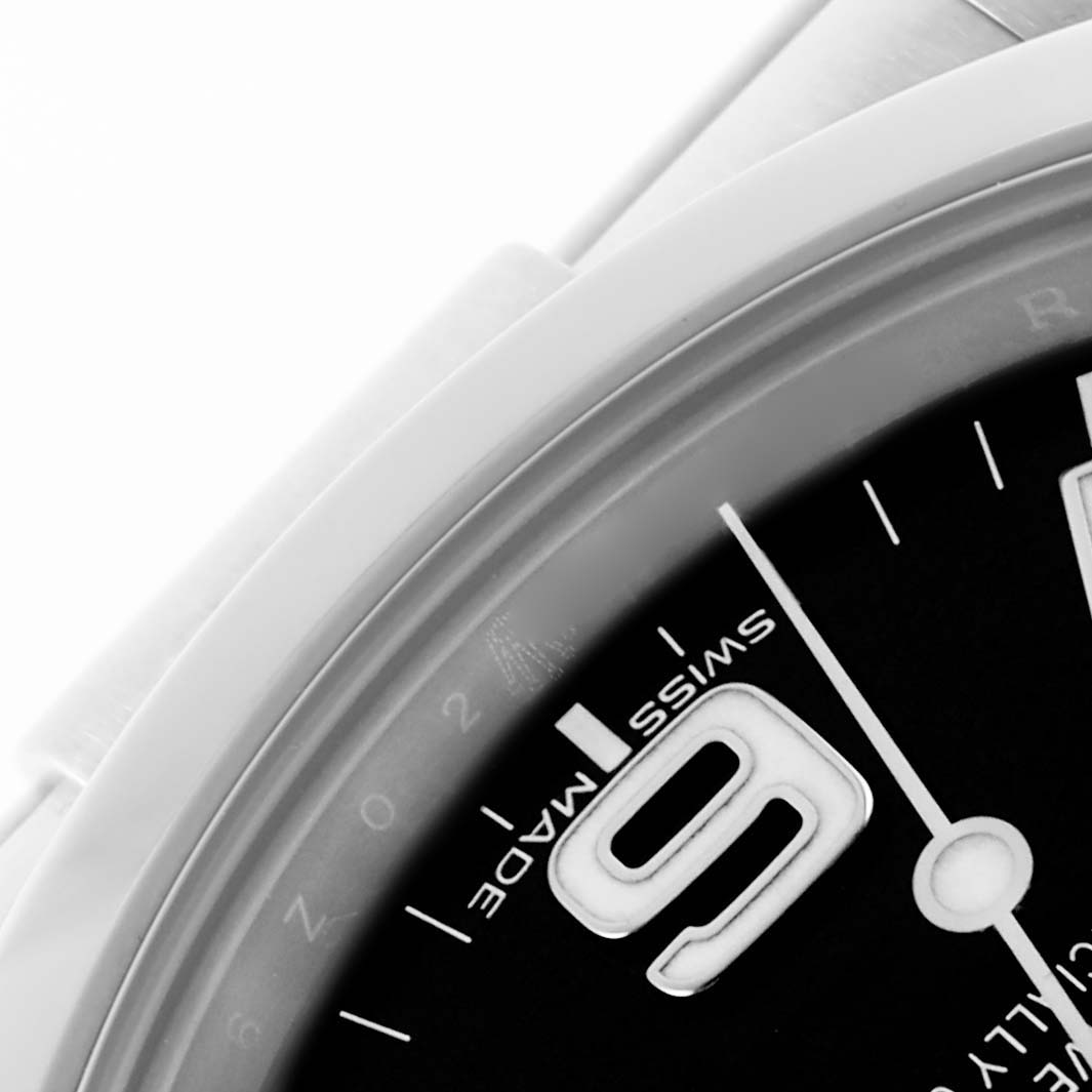 The image shows a close-up of the dial and part of the bezel of a Rolex Explorer 214270 Men's Stainless Steel Black Dial 214270 Men's Stainless Steel Black Dial watch.