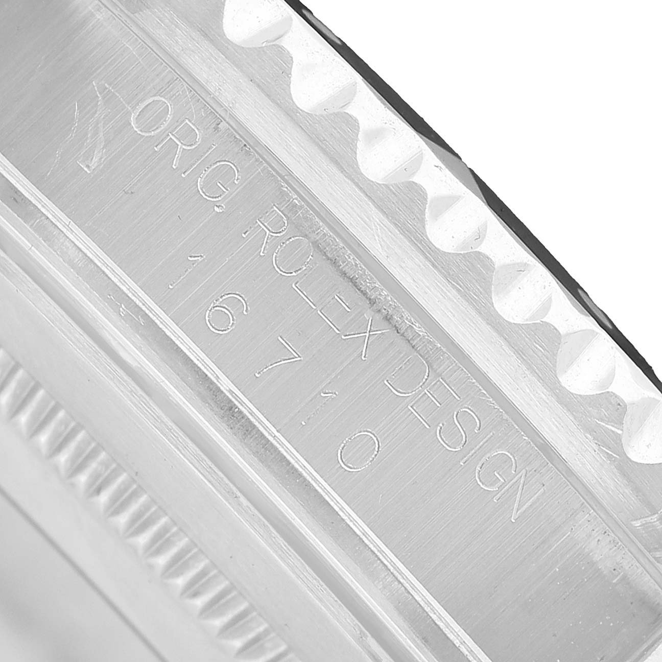 The image shows a close-up of the bezel edge and case side with engraving on a Rolex GMT-Master 16710 Men's Stainless Steel Black Dial.