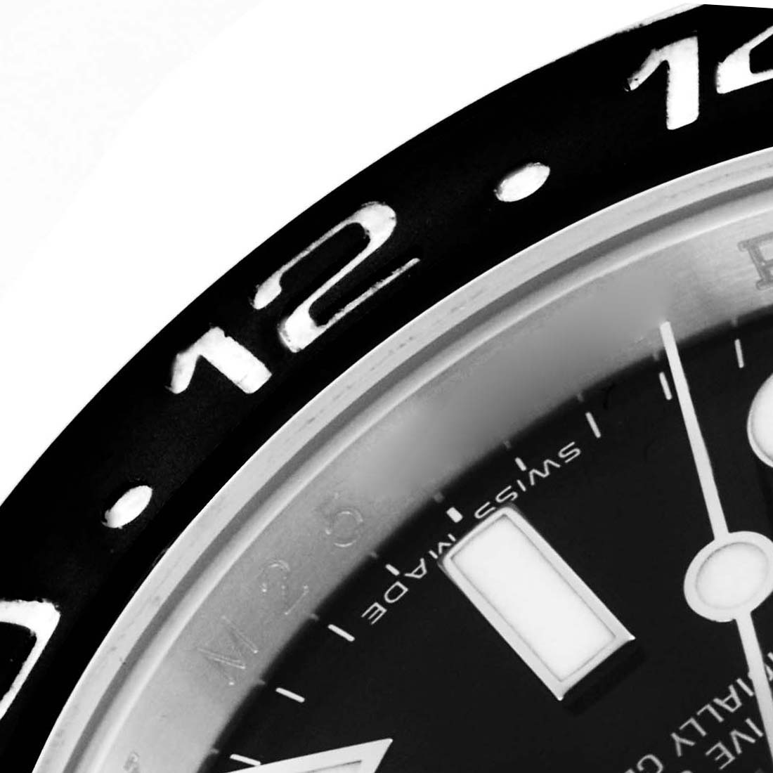 The image shows a close-up of the bezel and part of the dial of a Rolex GMT-Master 116710LN Men
s Stainless Steel Black Dial 116710LN Men
s Stainless Steel Black Dial watch, highlighting the 12 o
clock marker.