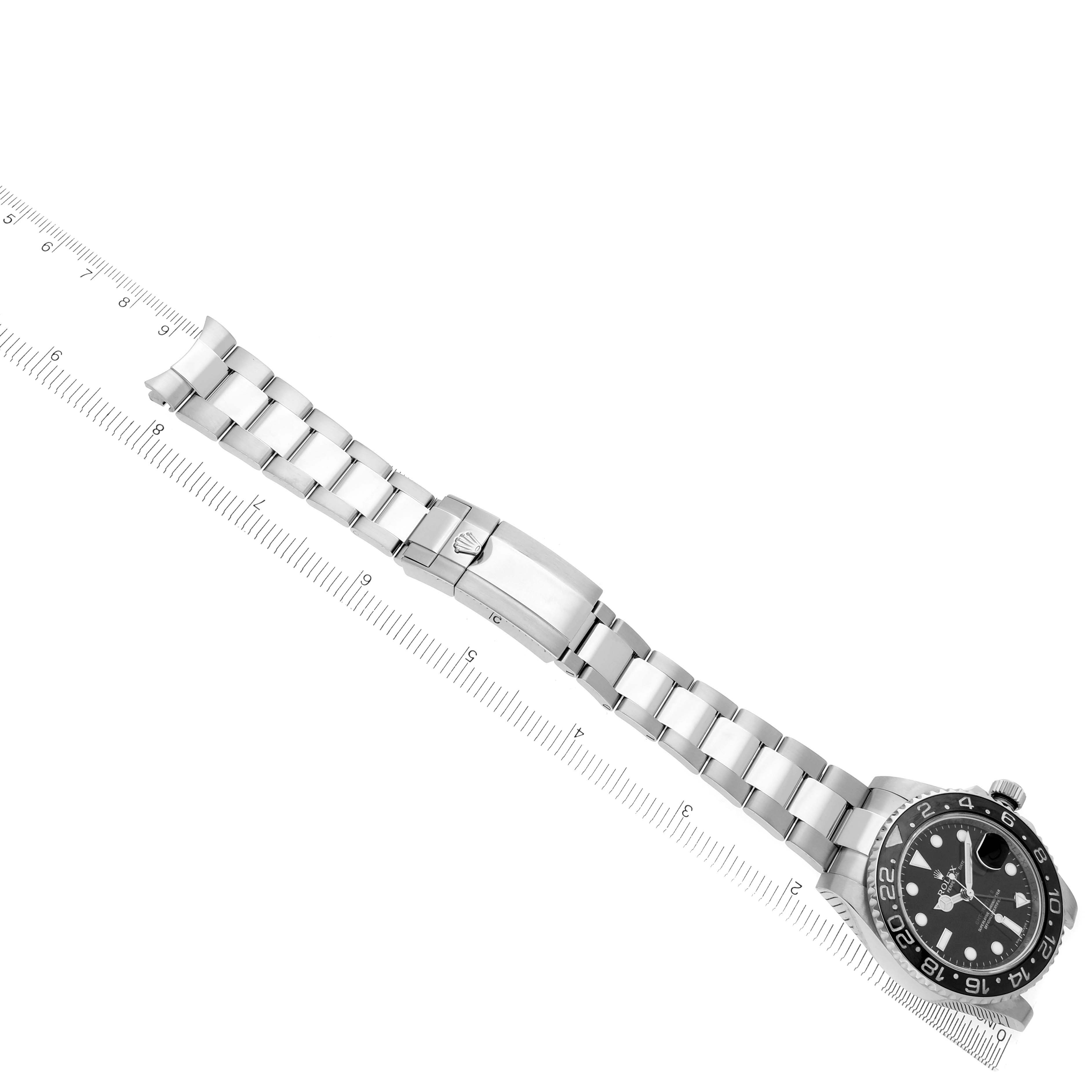 The Rolex GMT-Master 116710LN Men
s Stainless Steel Black Dial 116710LN Men
s Stainless Steel Black Dial watch is shown from a top view, displaying the bezel, dial, bracelet, and clasp alongside a ruler.