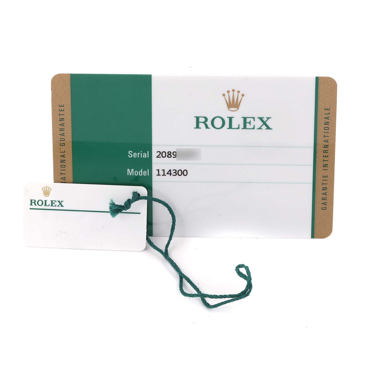 The image shows the warranty card and tag for a Rolex Oyster Perpetual 114300 Men's Stainless Steel Grey Dial 114300 Men's Stainless Steel Grey Dial, model 114300.